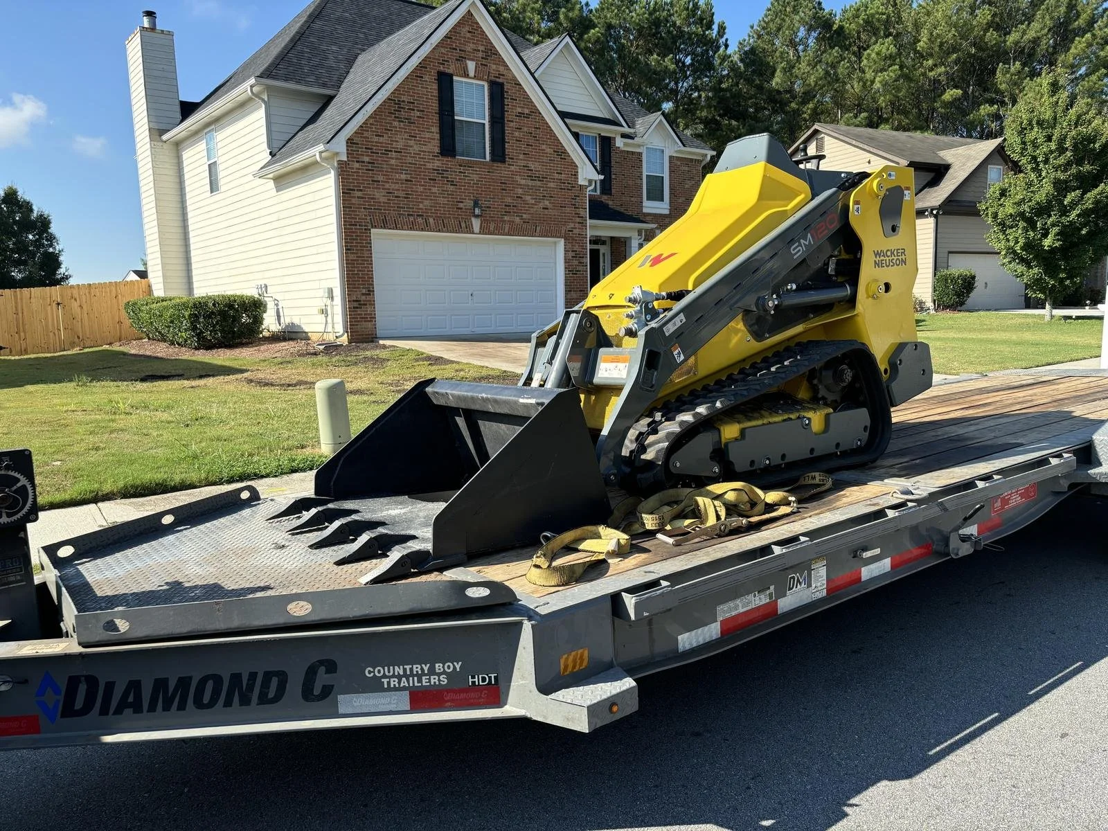 Mini-skid on trailer being delivered to Loganville GA home