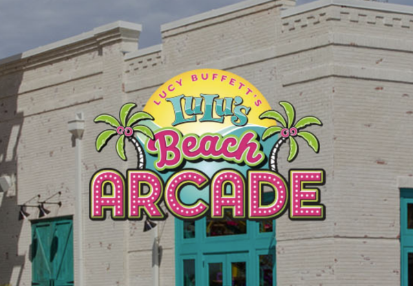 Sign for LuLu's Beach Arcade on a brick building with colorful graphics of palm trees.