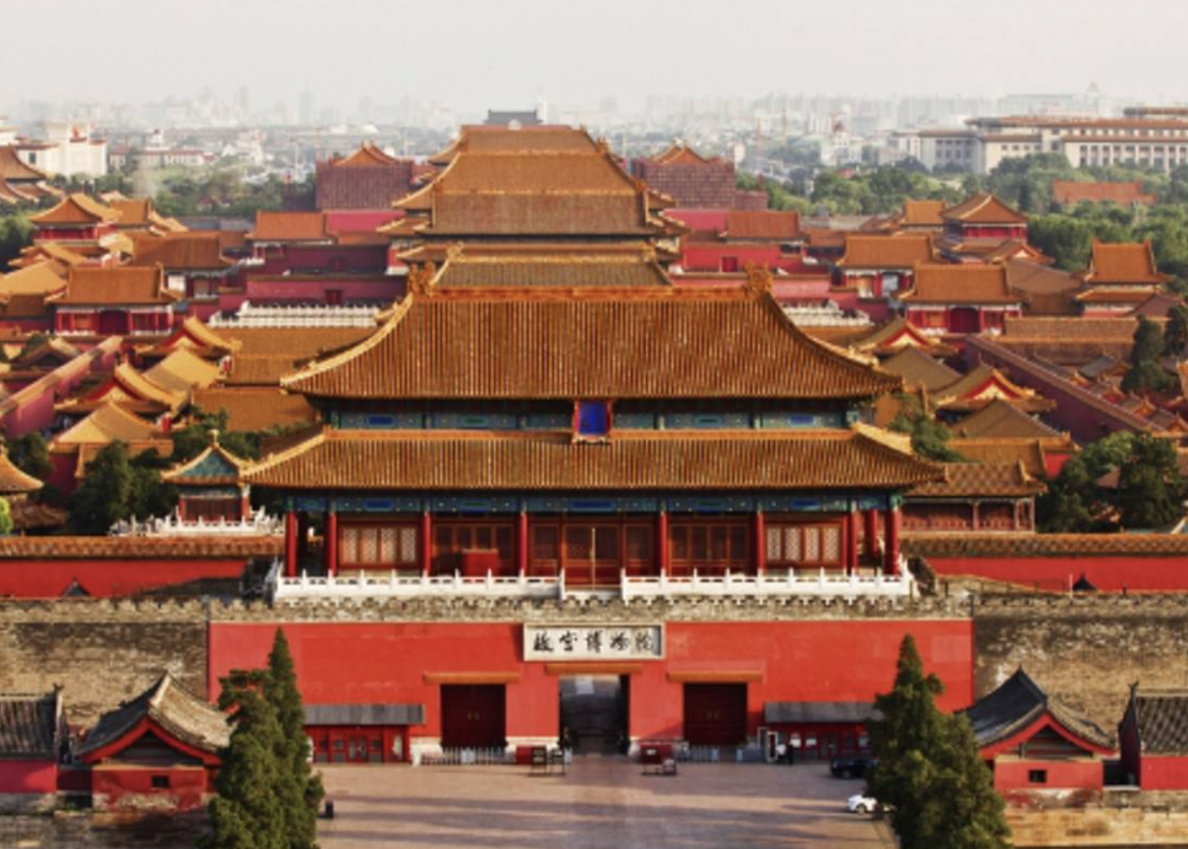 Aerial view of the Forbidden City in Beijing, China, showing traditional Chinese architecture with red walls and golden roofs.
