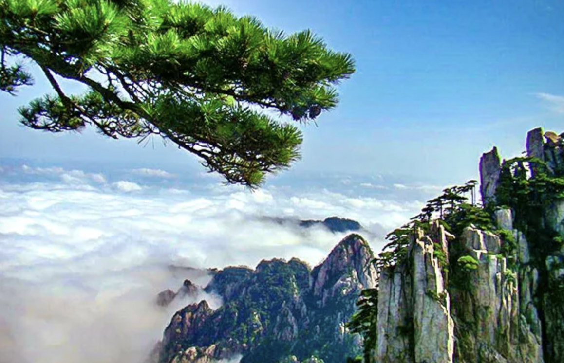 Mountain landscape with rocky peaks, pine trees on cliff edges, and a cloud-filled sky with blue hues.