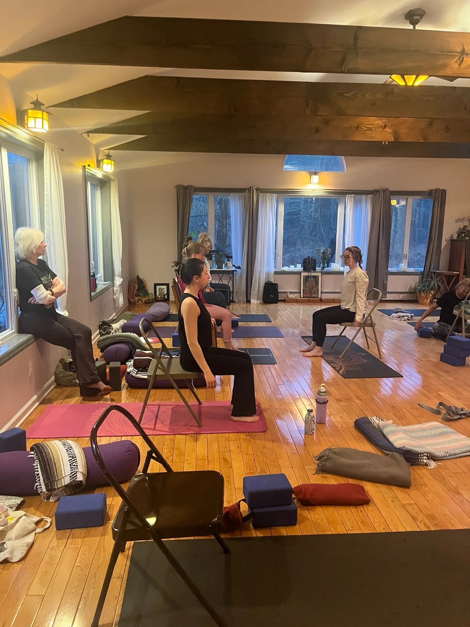 Students engaged in a hands-on anatomy lesson during yoga teacher training at Shakti Yoga in Woodstock, NY..