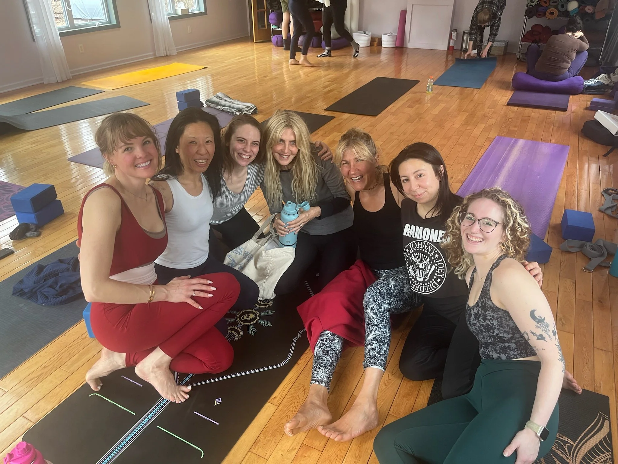 Graduates of the Yoga Alliance-certified teacher training at Shakti Yoga in Woodstock celebrating with certificates in hand.