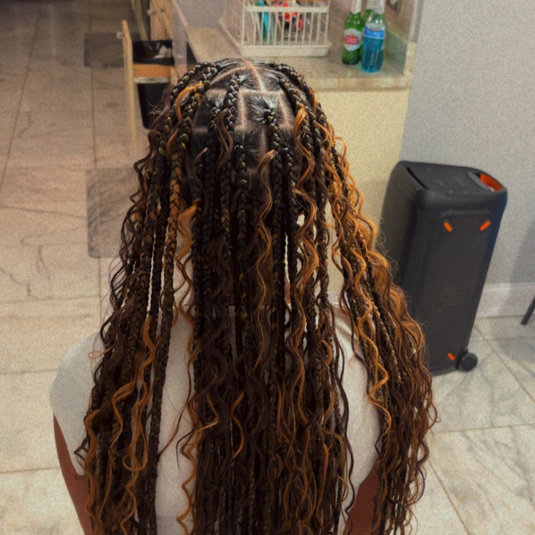 Knotless braids with copper highlights at Kingdom Touch