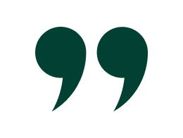 Open quotation marks in large dark green font on a black background.