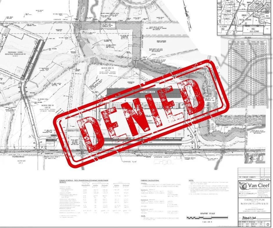 A detailed construction or land development blueprint with a bold red 'DENIED' stamp across it.