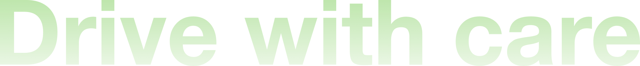 Partial view of a sign with the words 'Drive with care' in large green letters on a black background.