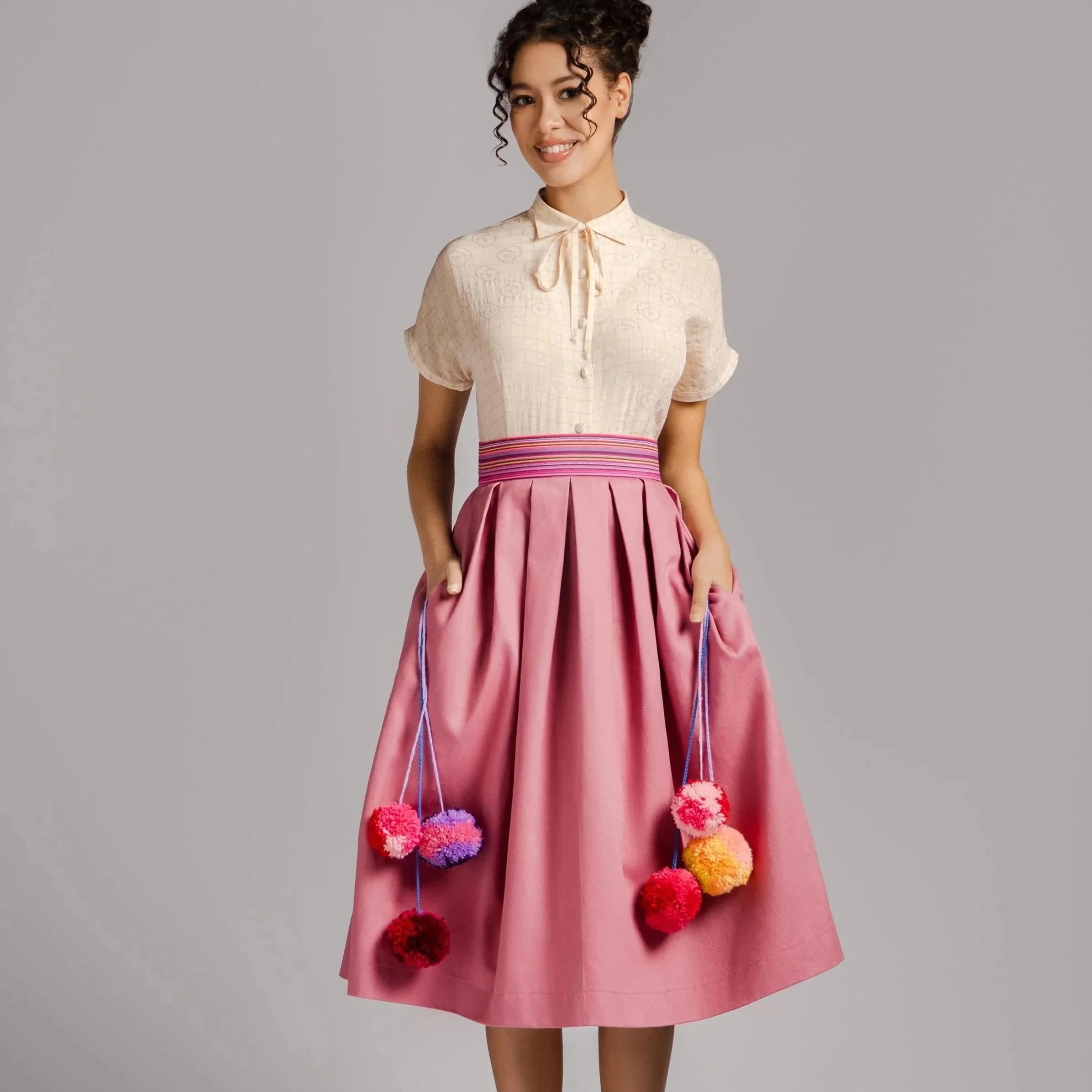 Stefanny – Pink Pleated Midi Skirt with Pompom Detail