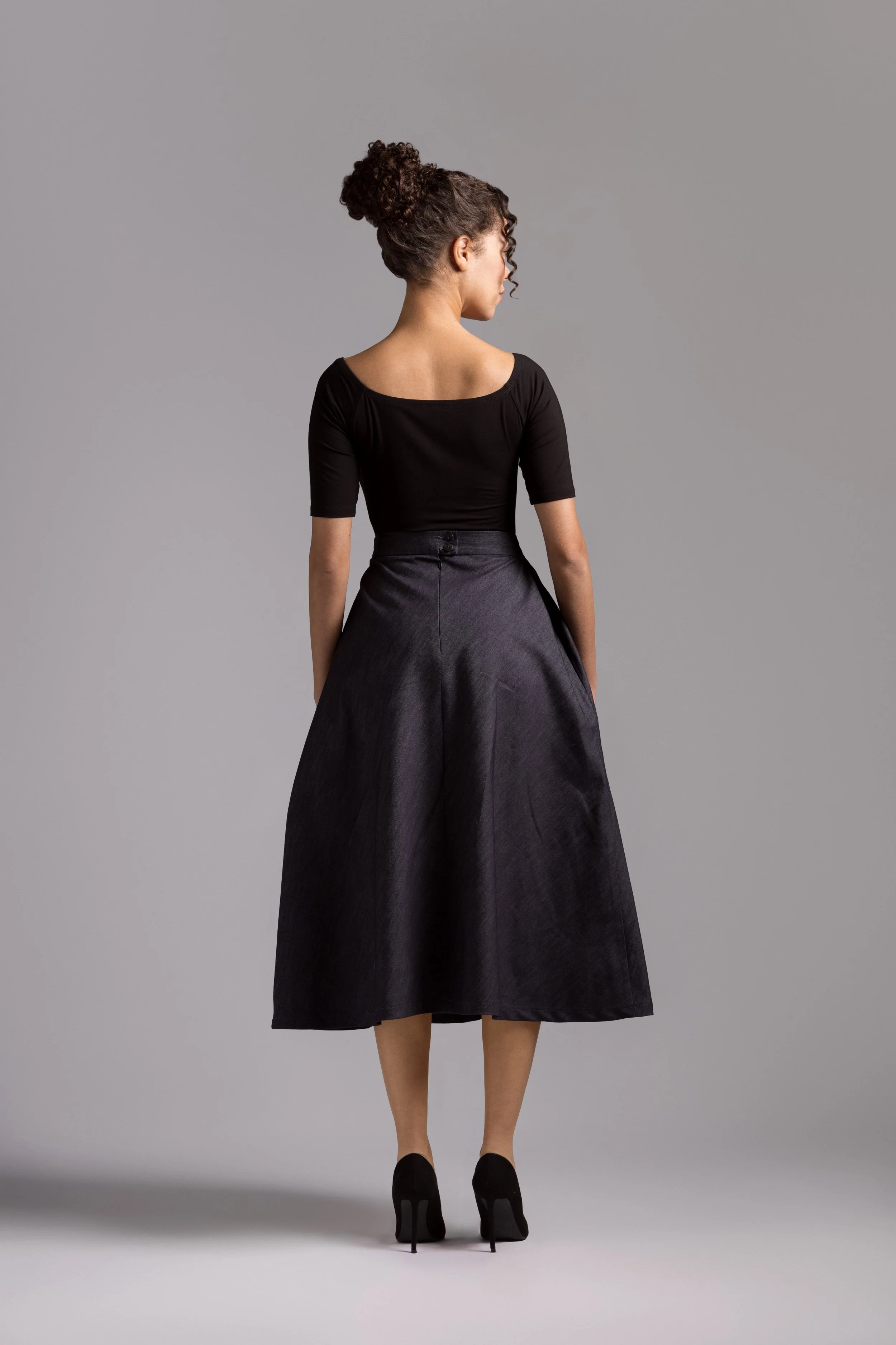 Model wearing a a modest navy denim A-line midi skirt, 1940s inspired, Tzniut style