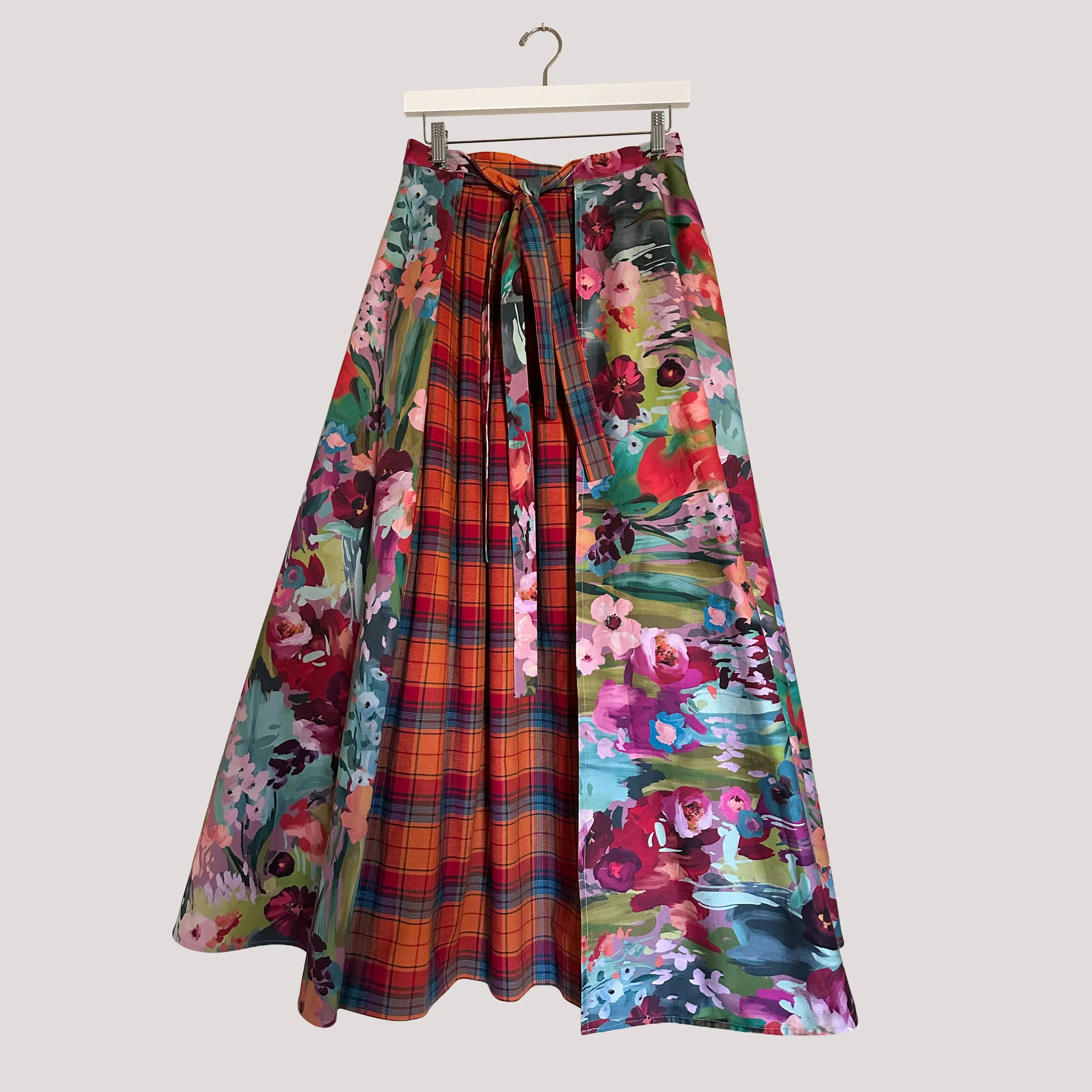 Reversible wrap midi skirt showing the floral side with flowing shape.
