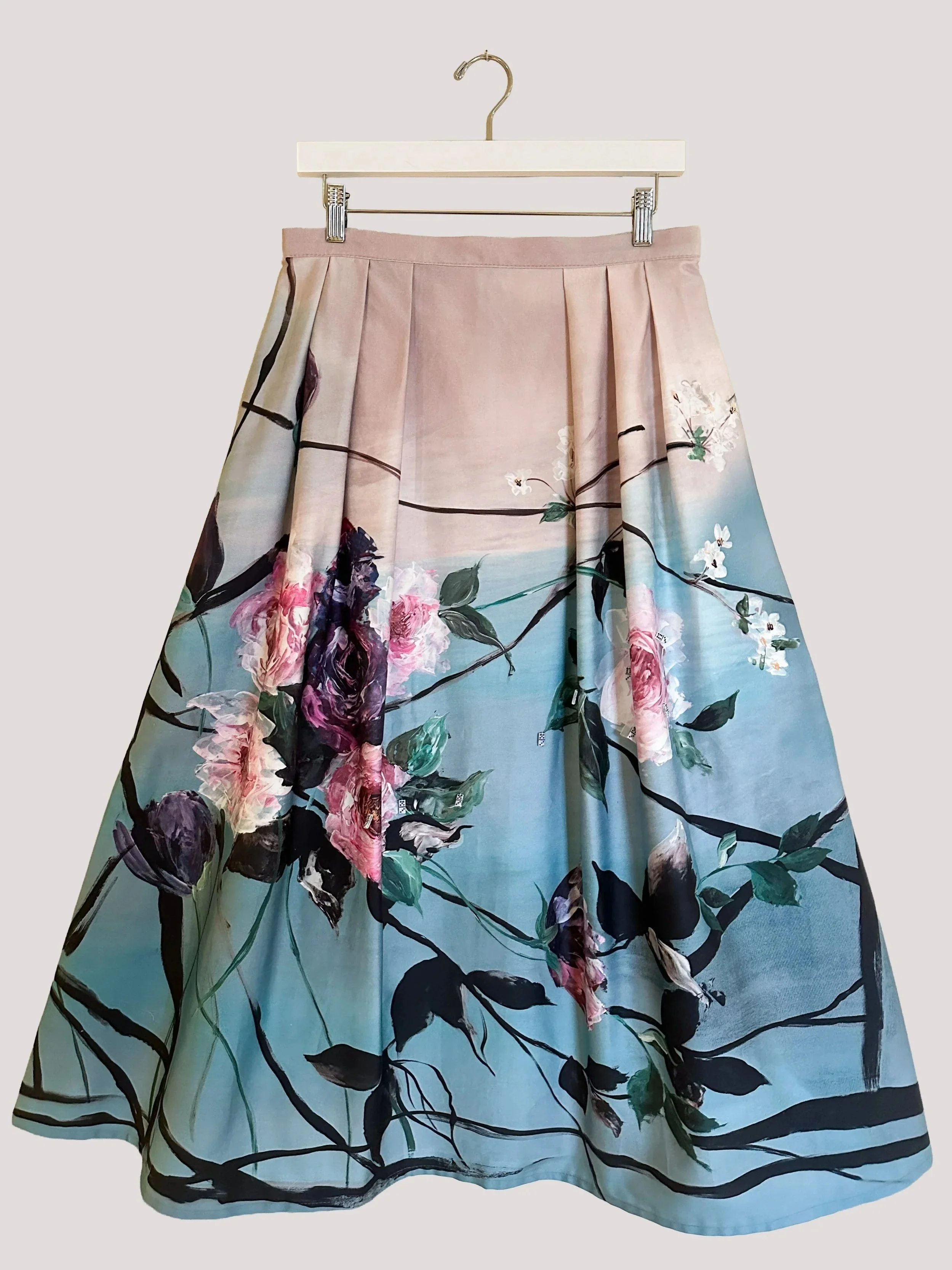 Women’s blue pleated floral midi skirt with aquarelle watercolour print.