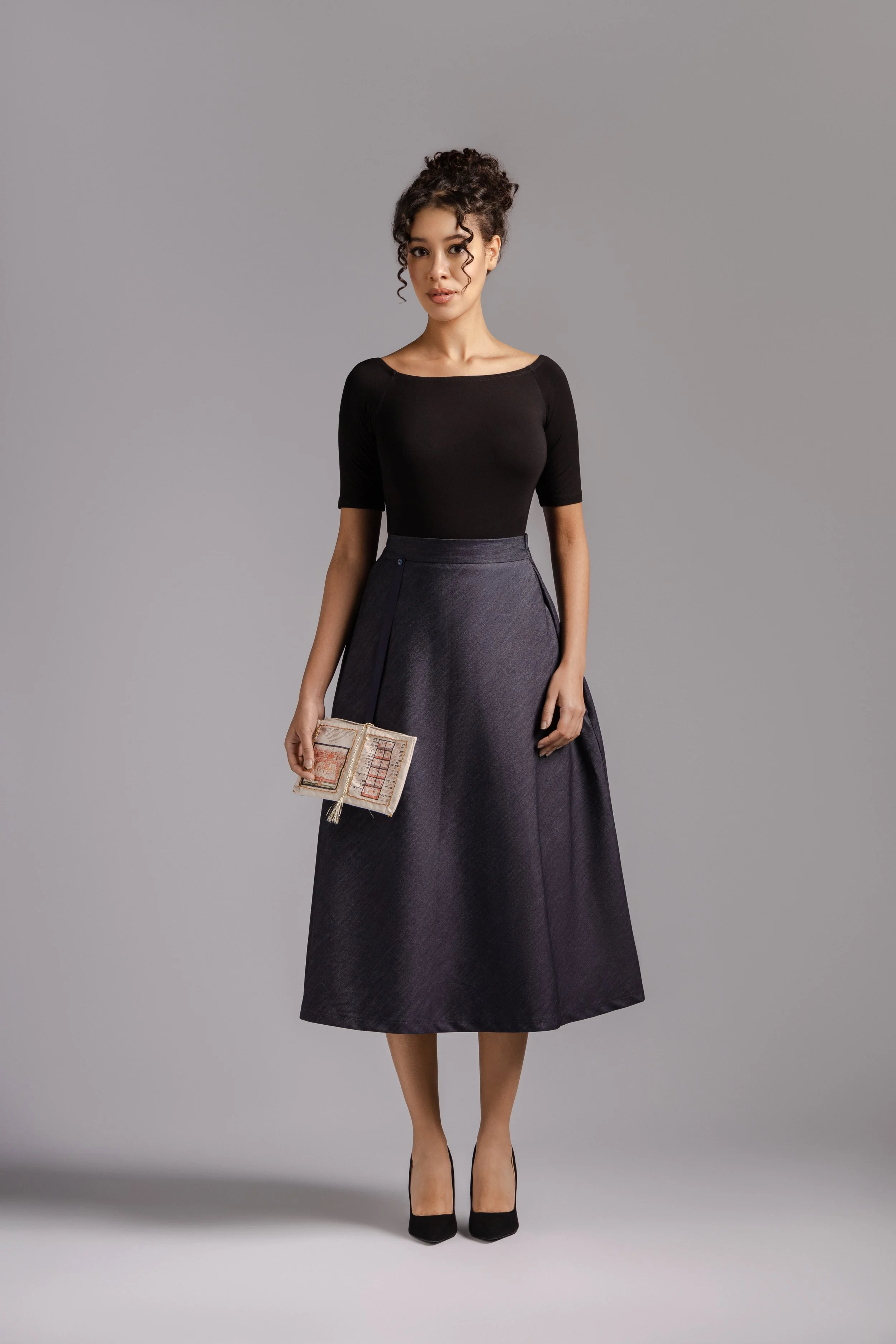 ellNavy denim A-line midi skirt with structured silhouette.