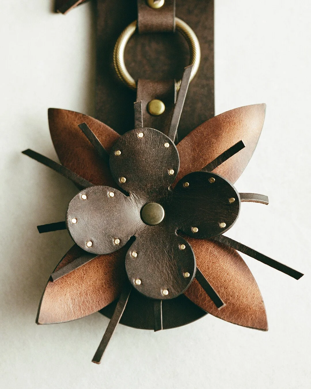 Close-up of an Isabel Marant leather flower accessory with metal studs showcasing artisanal craftsmanship and bohemian design