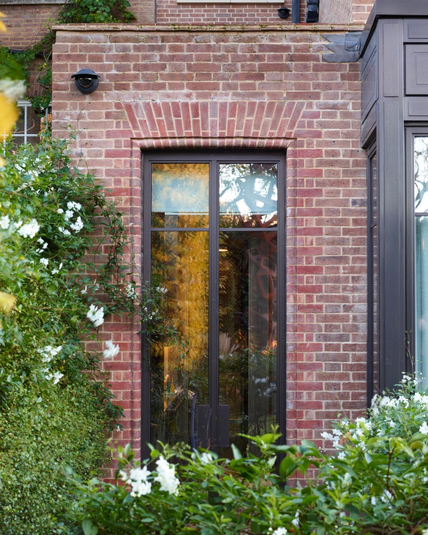 Timber, metal, and stone.
A measured composition beneath the jasmine.