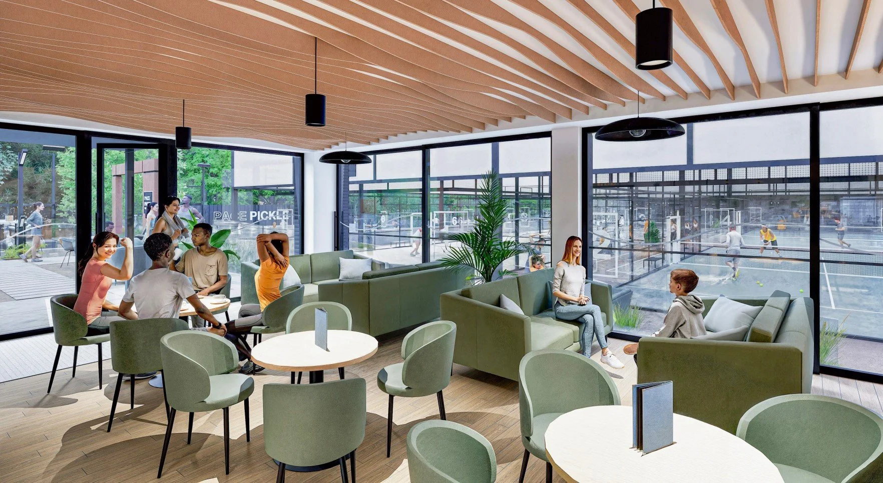 A modern indoor lounge area with large windows showing an outdoor sports court. Group of young people sitting and talking, some stretching, and a woman doing a yoga pose. The lounge has green chairs and sofas, wooden floors, and a wooden ceiling with