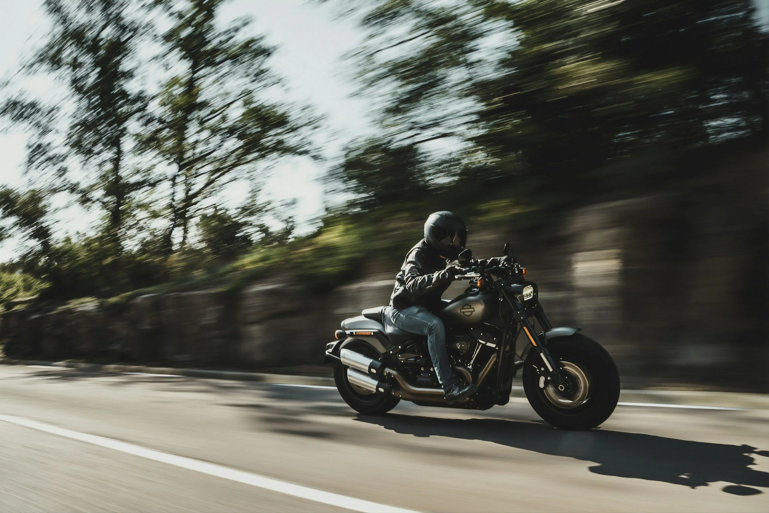 motorcycle driving down road.