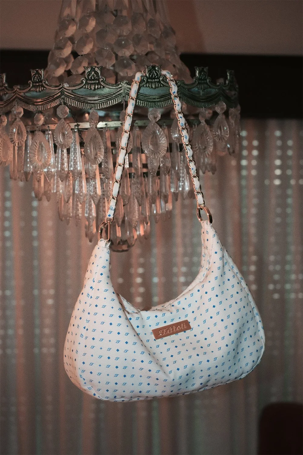 Sienna bag hanging from a chandelier.