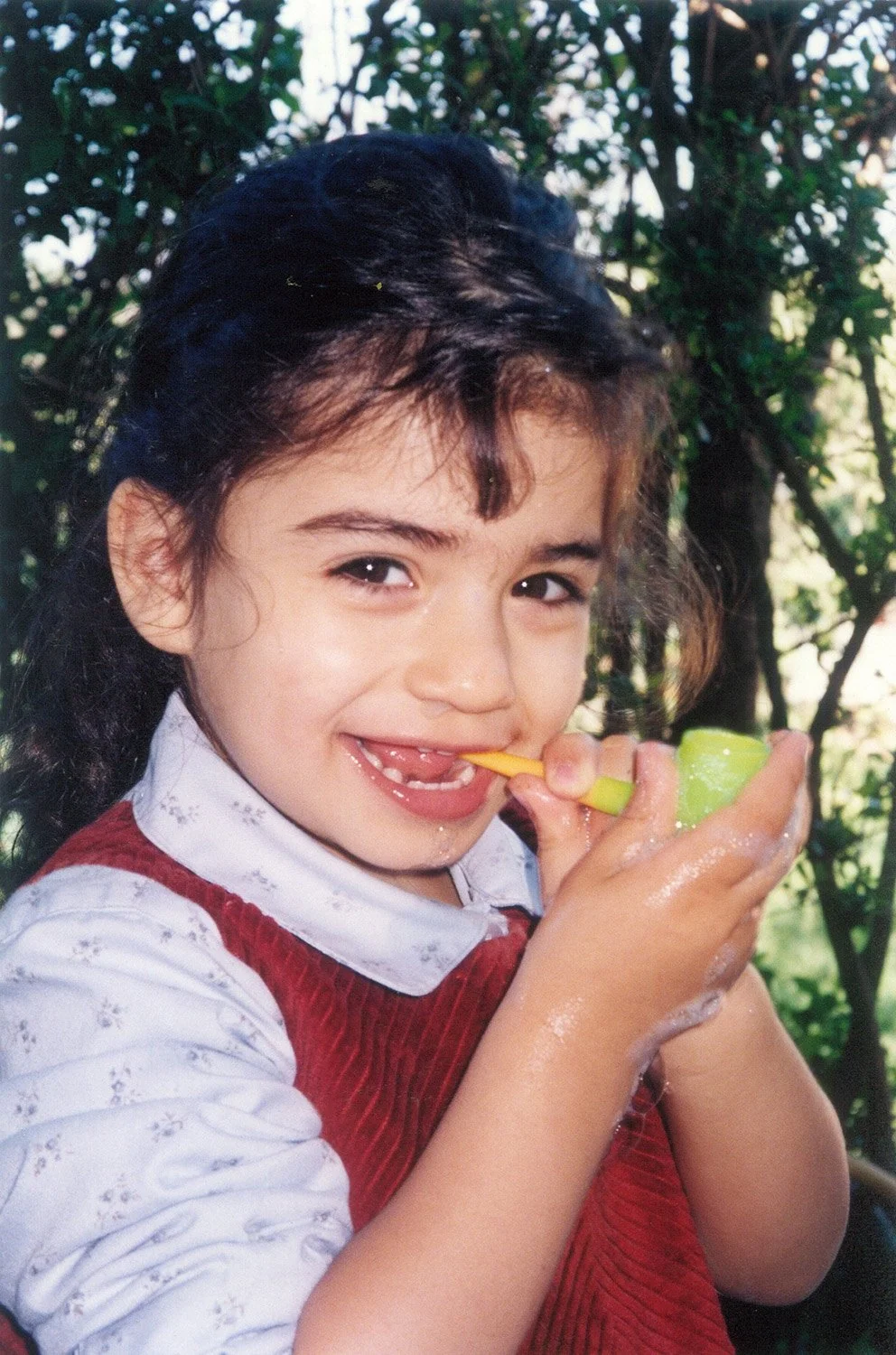 Clarisse as a child, playing with bubbles.
