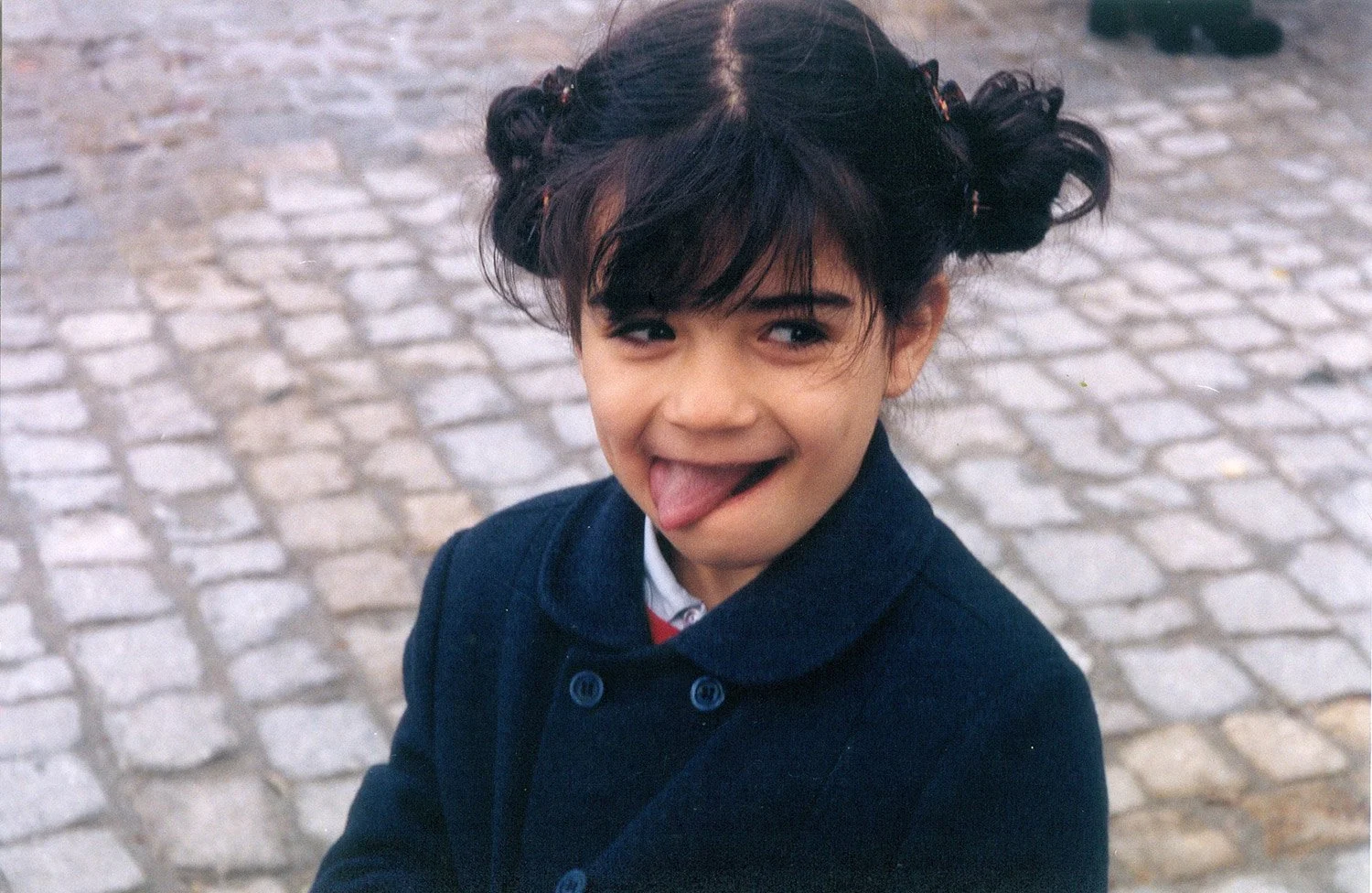 Clarisse as a child, pulling a face on her baptism.