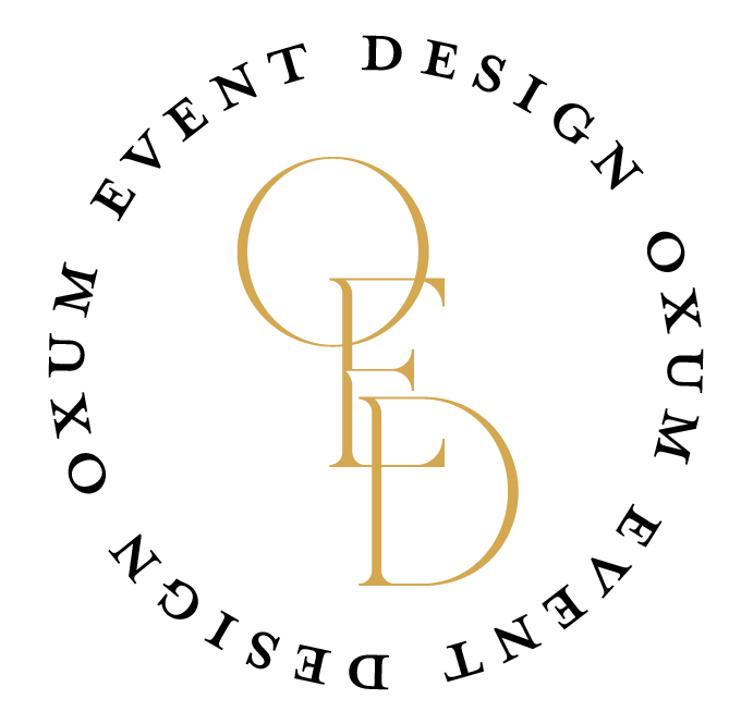 Gold interlocked letters Q, G, E, D on black background