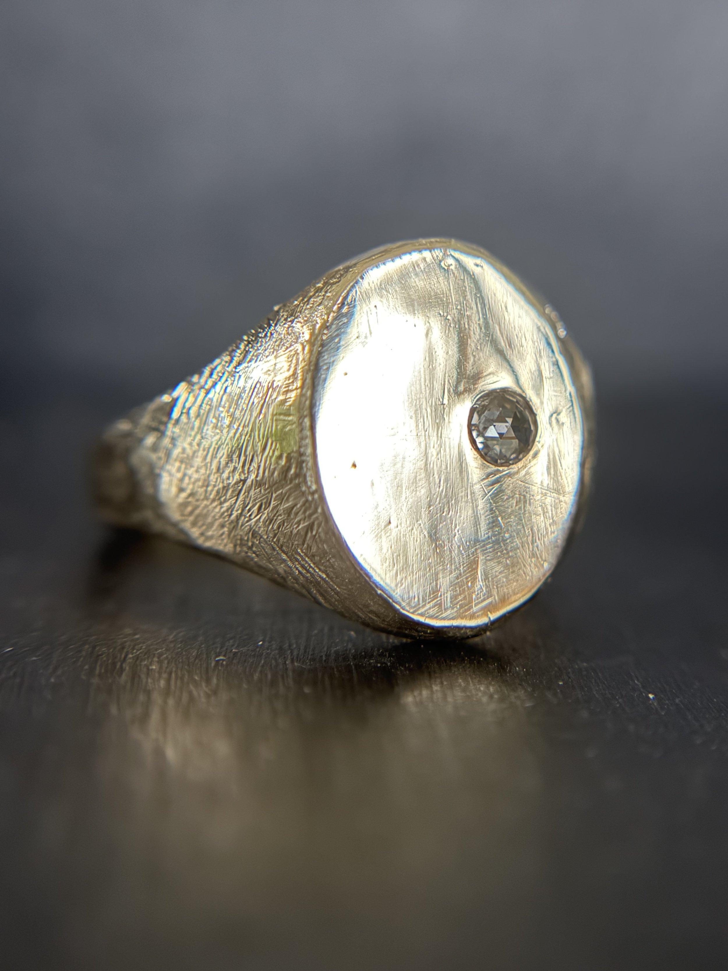 A signet ring for a new chapter of life in a new city. 14K.   A trail of diamonds embedded in the side. Some hidden, some revealed. Meant to symbolize new connections, new potential.  For the full story, head to instagram. 