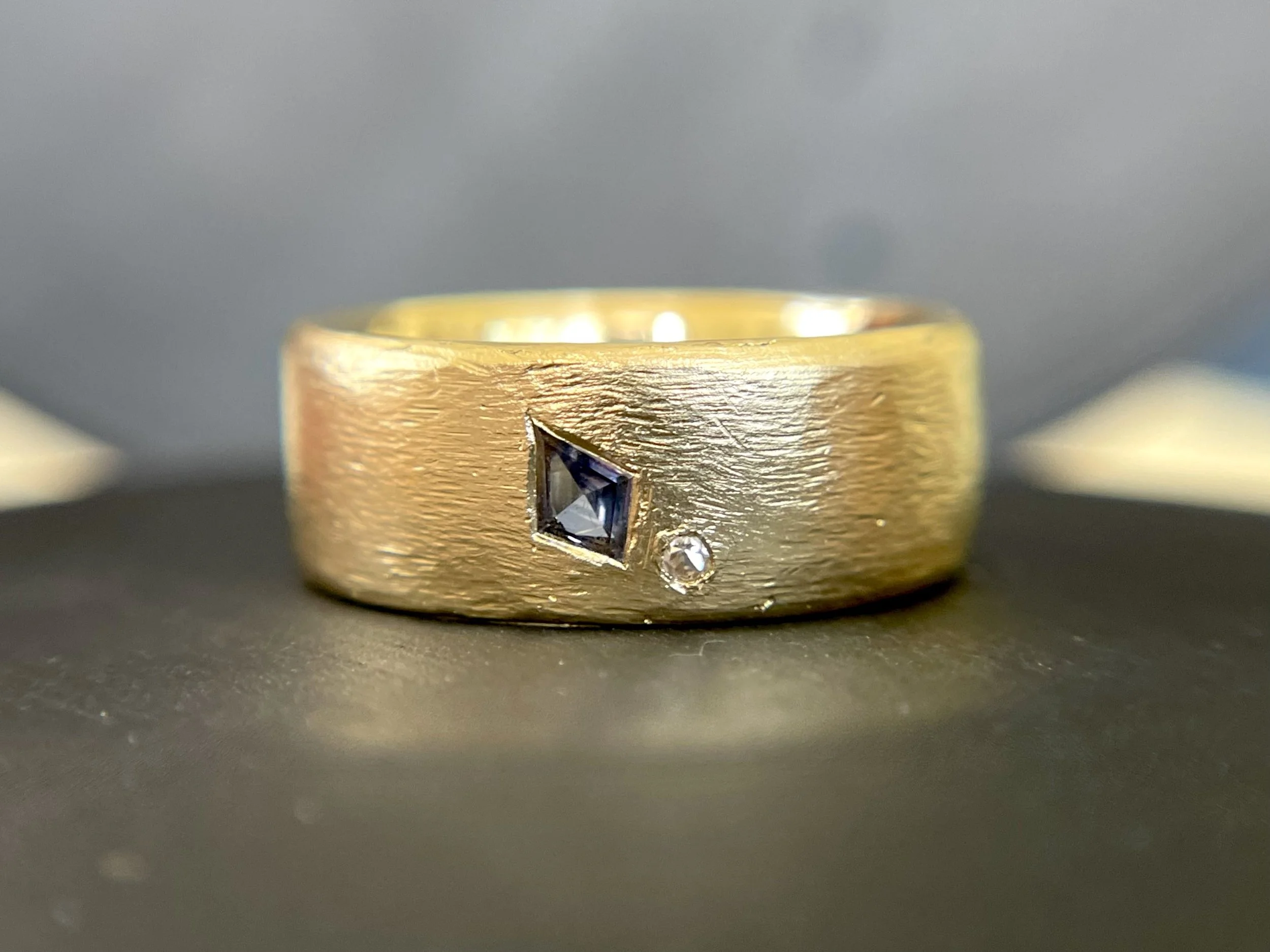 Hand carved 18K gold with sapphire and diamond wedding ring.