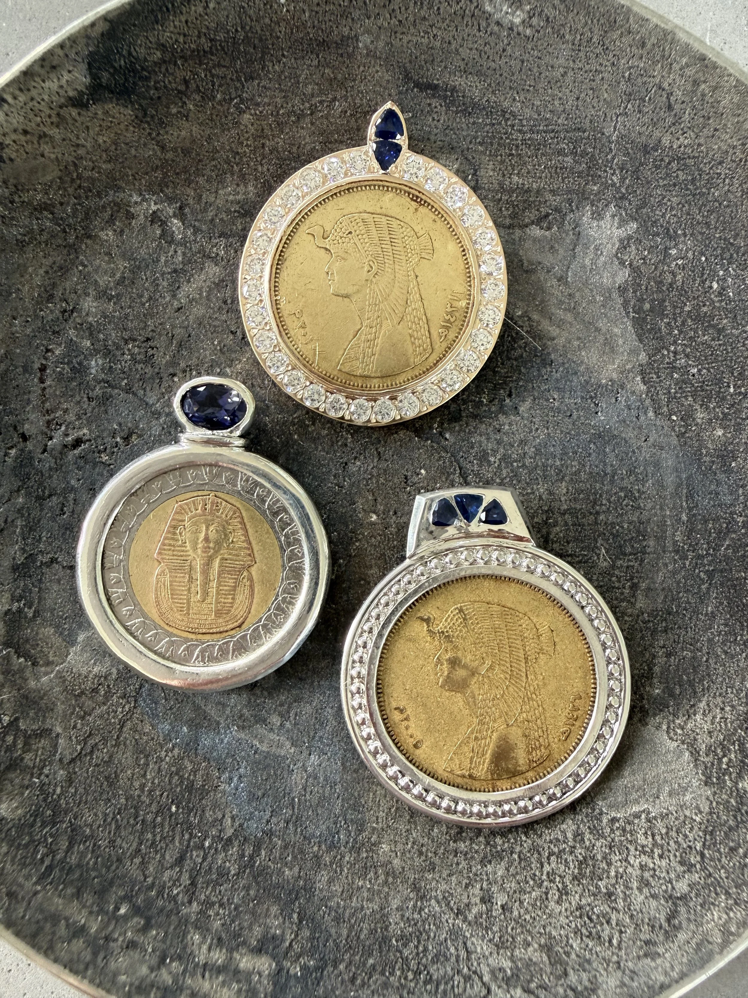 Old Egyptian coins made for family. Sterling with with iolite. Sterling silver with sapphire. !0K gold with sapphire and diamond. 