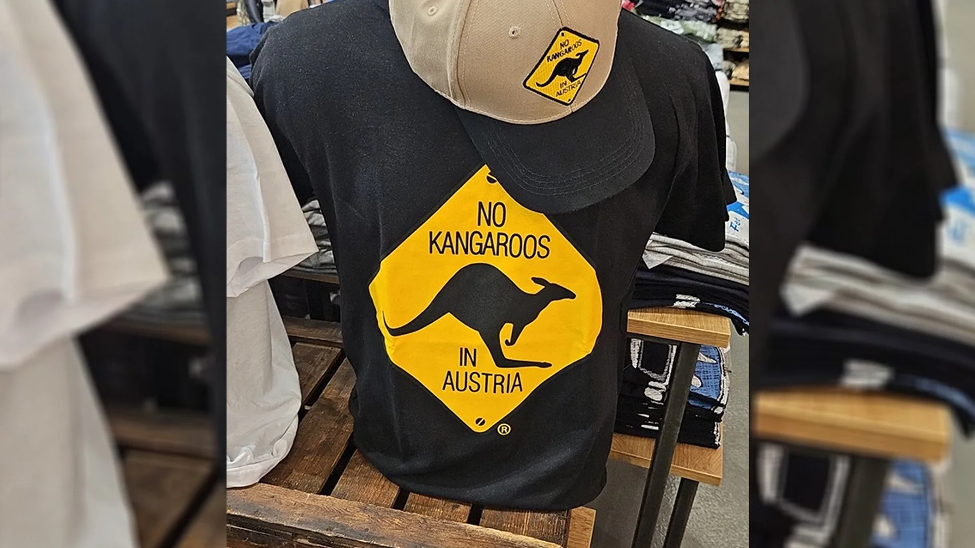 Black t-shirt and beige baseball cap with matching 'No Kangaroos in Austria' stickers featuring a silhouette of a kangaroo