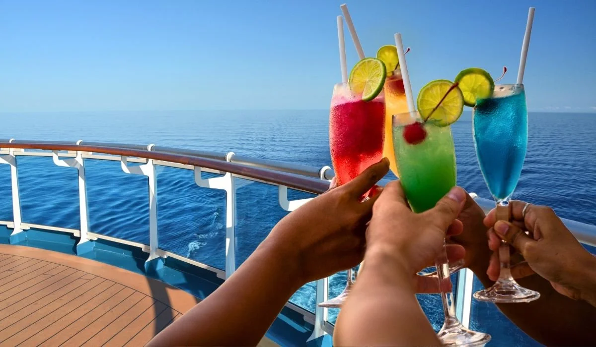 A colorful selection of beer, cocktails, frozen drinks, and specialty beverages displayed beside a cruise ship pool.