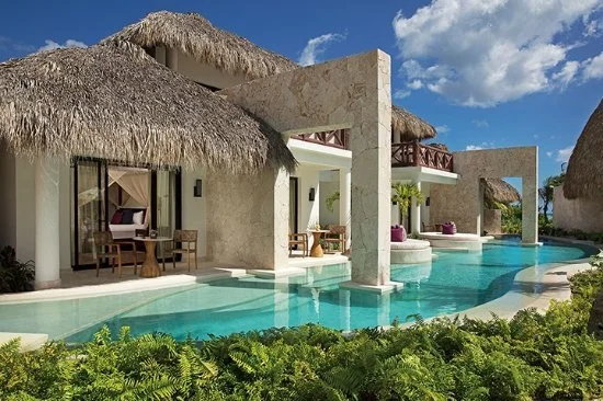 Luxury thatched-roof bungalow suites with private terraces and swim-out pool access at Secrets Cap Cana Resort & Spa.