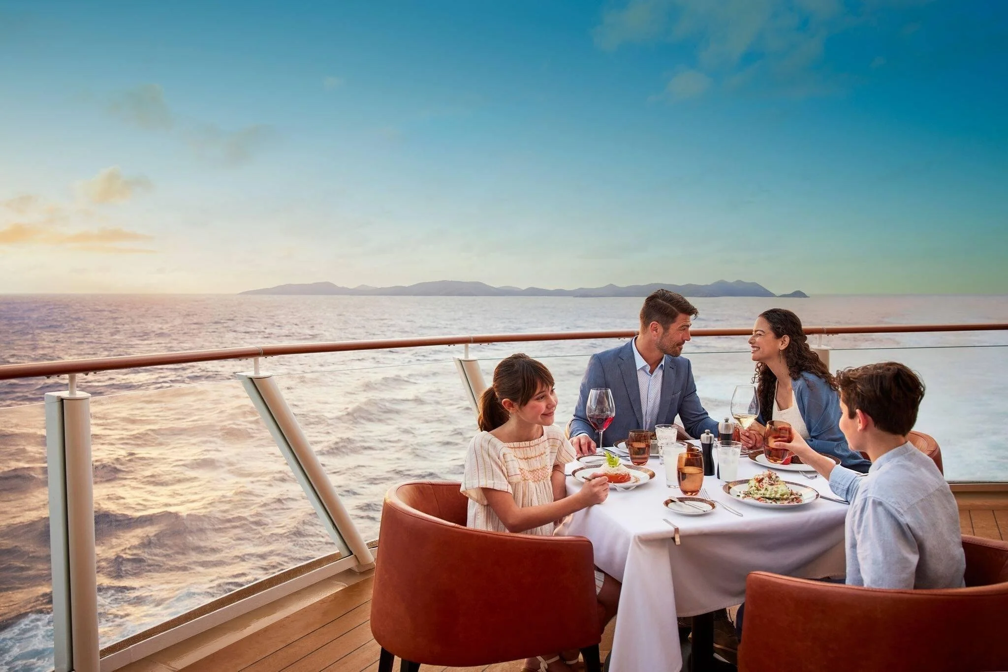 Family sharing a meal at a cruise ship restaurant.