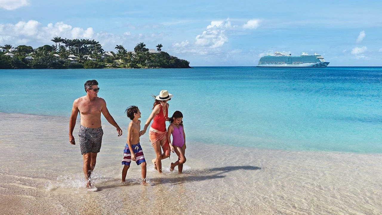 Family walking together along a beach during a cruise port stop.