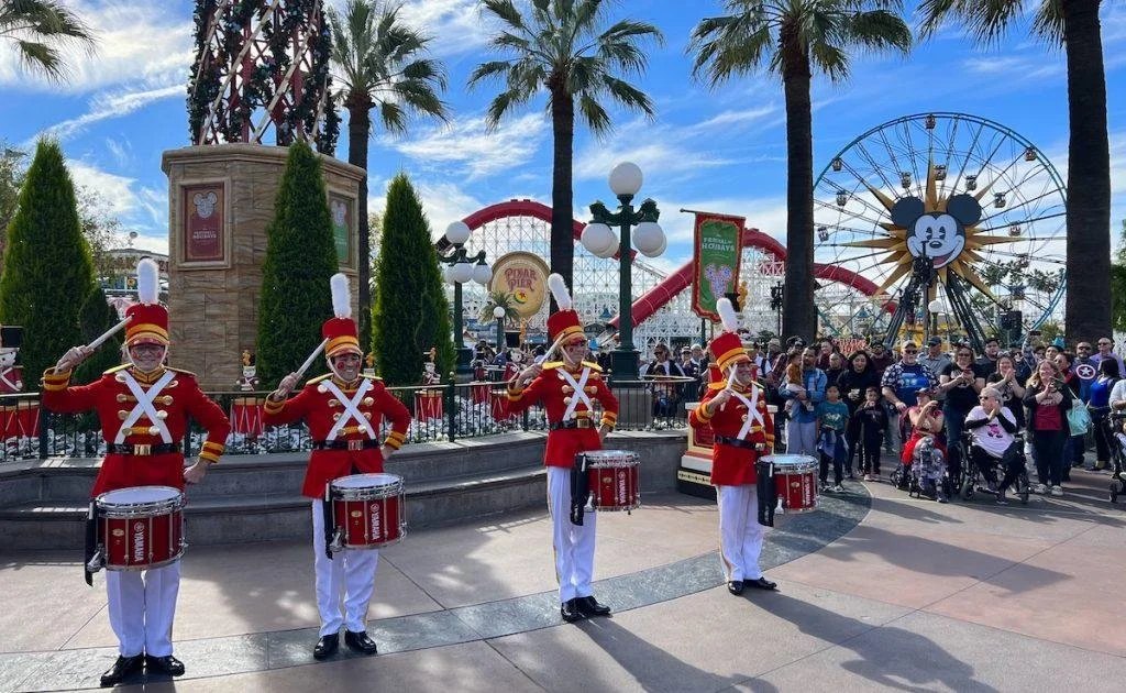 Colorful musicians and dancers performing during the Disney Festival of Holidays at California Adventure.
