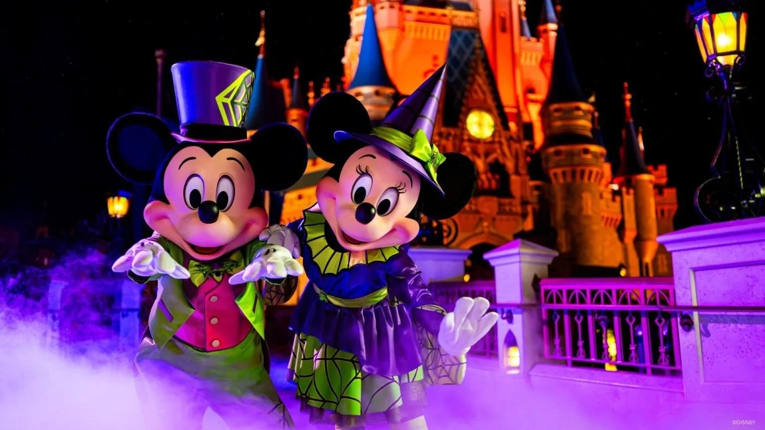 Mickey Mouse and Minnie Mouse greet guests in colorful Halloween costumes during Mickey's Not-So-Scary Halloween Party.