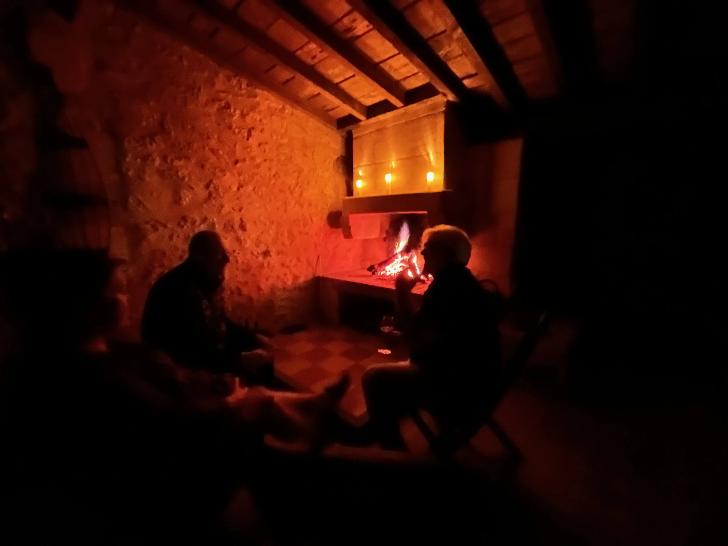 Sharing a conversation with wine and good friends near the fireplace in the outdoor kitchen.