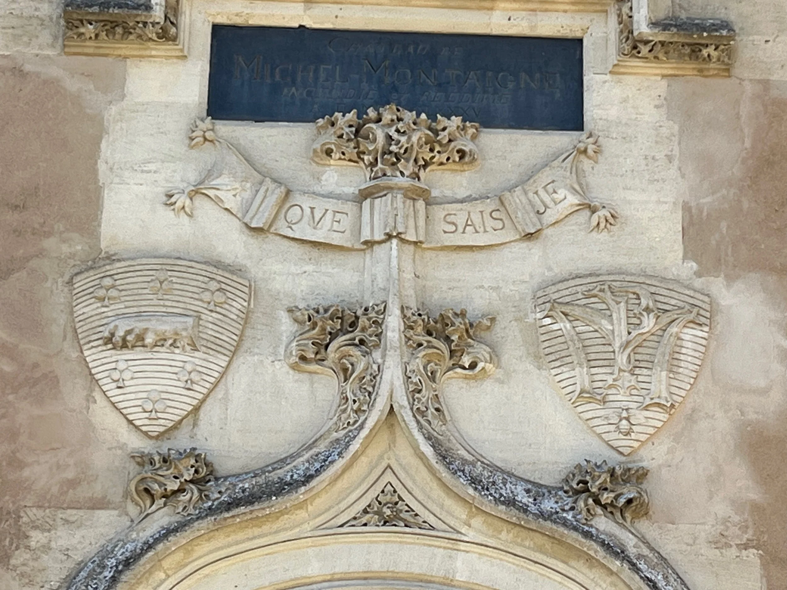 Close up on the doorway to the château with Montaigne’s famous saying “Que sais je?” or “what do I know?"