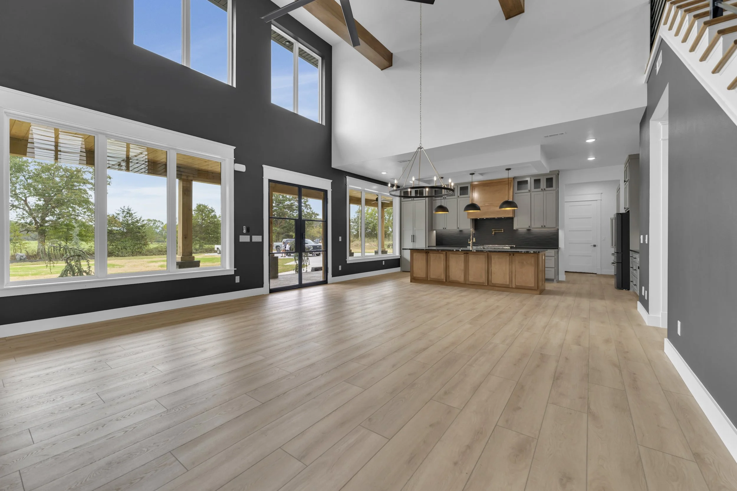Shot From the Bottom of the Stairs Displaying the Kitchen and Living Room