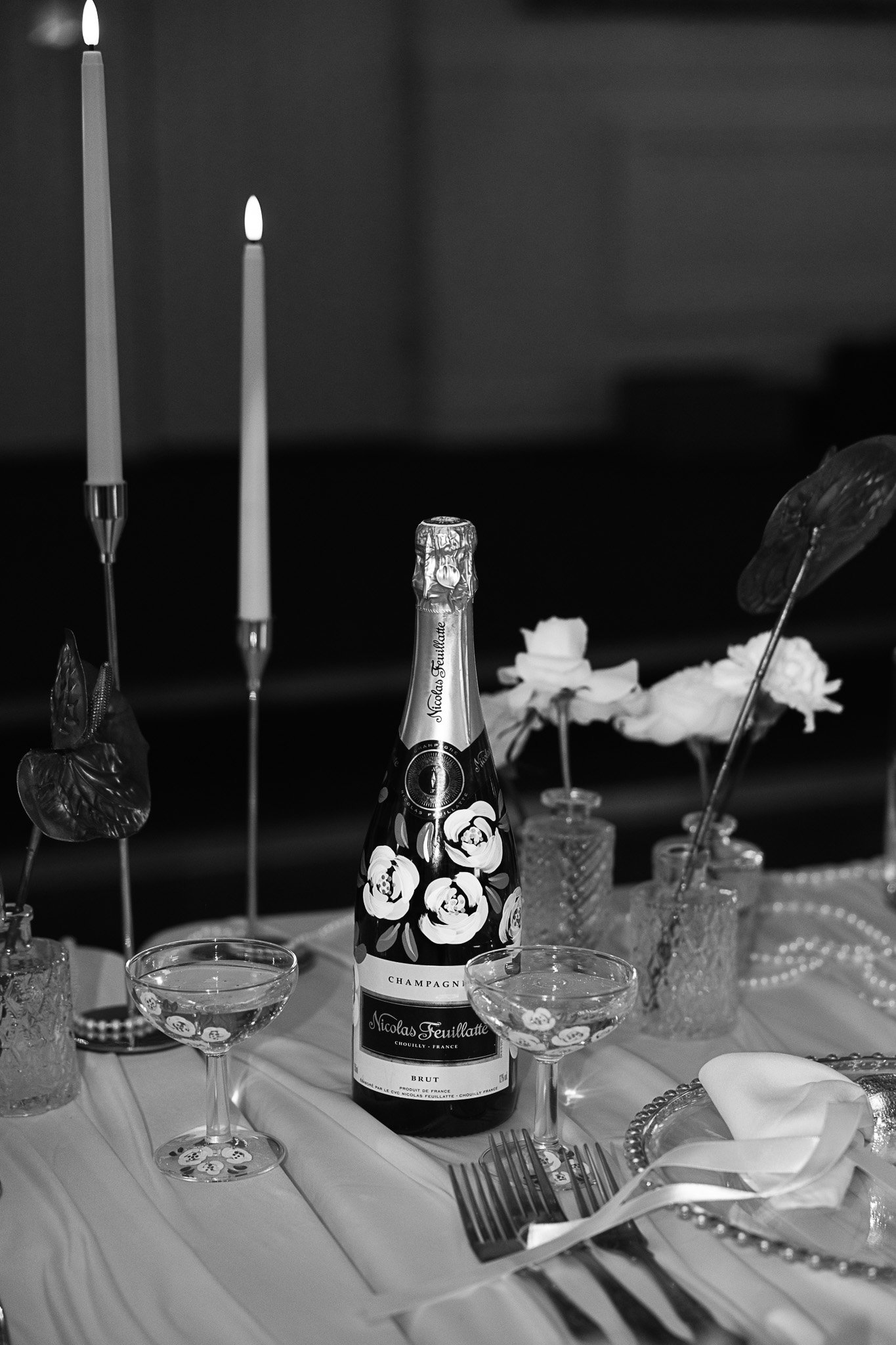 Wedding table detail featuring champagne and candle styling at a Kent wedding venue.