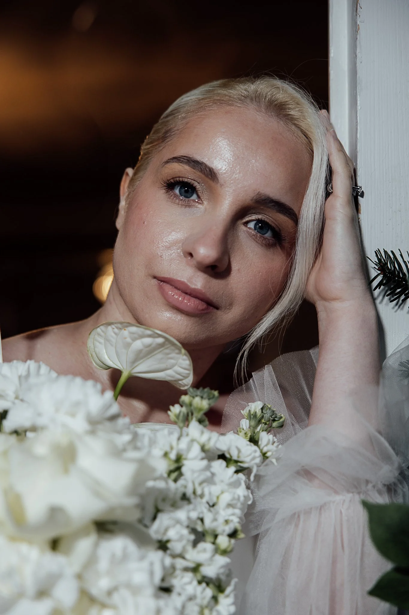 Soft bridal portrait featuring natural makeup and white wedding florals styled for a romantic Kent shoot.