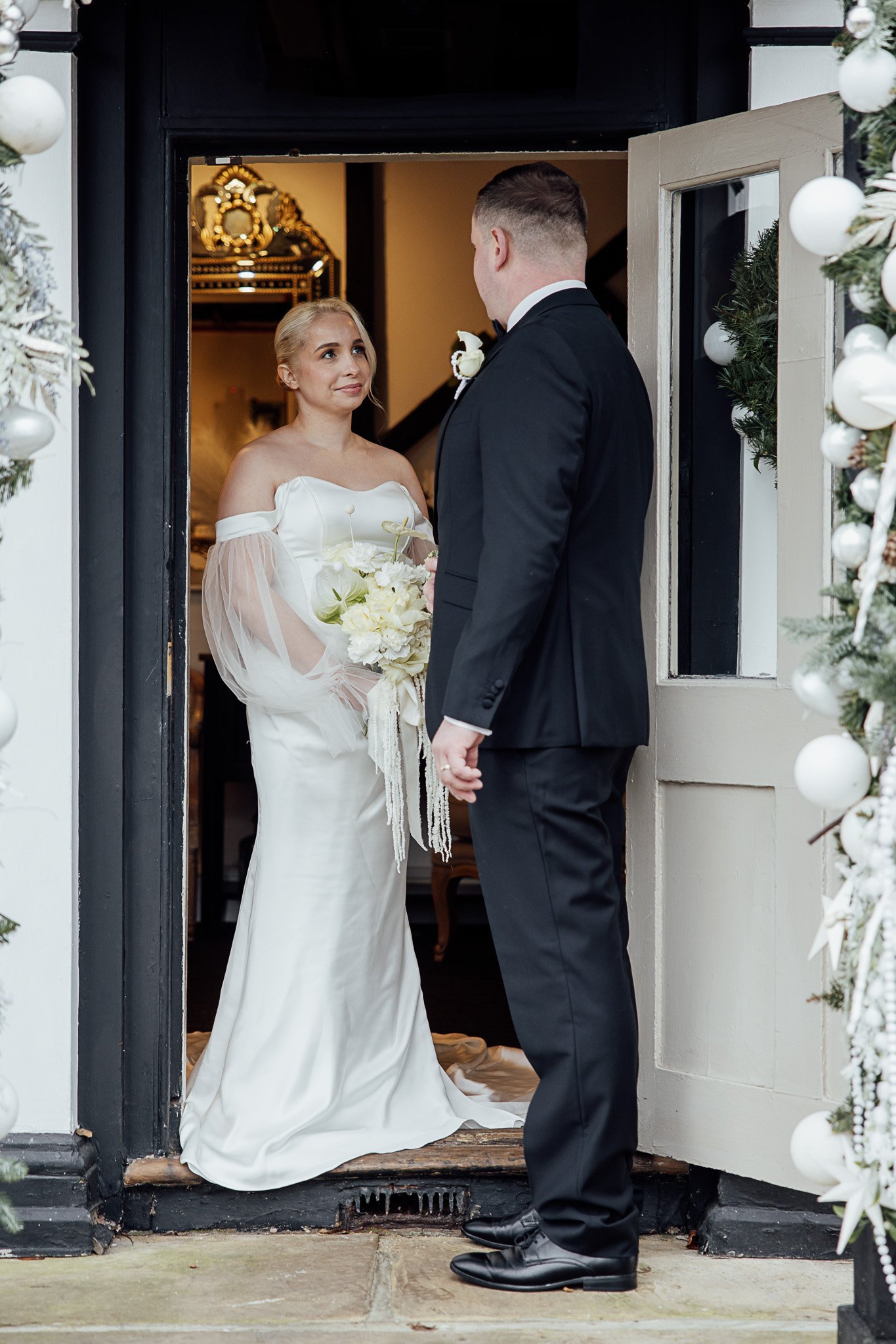Bride and groom moment at The Orchard wedding venue, featuring elegant bridal styling and white florals.
