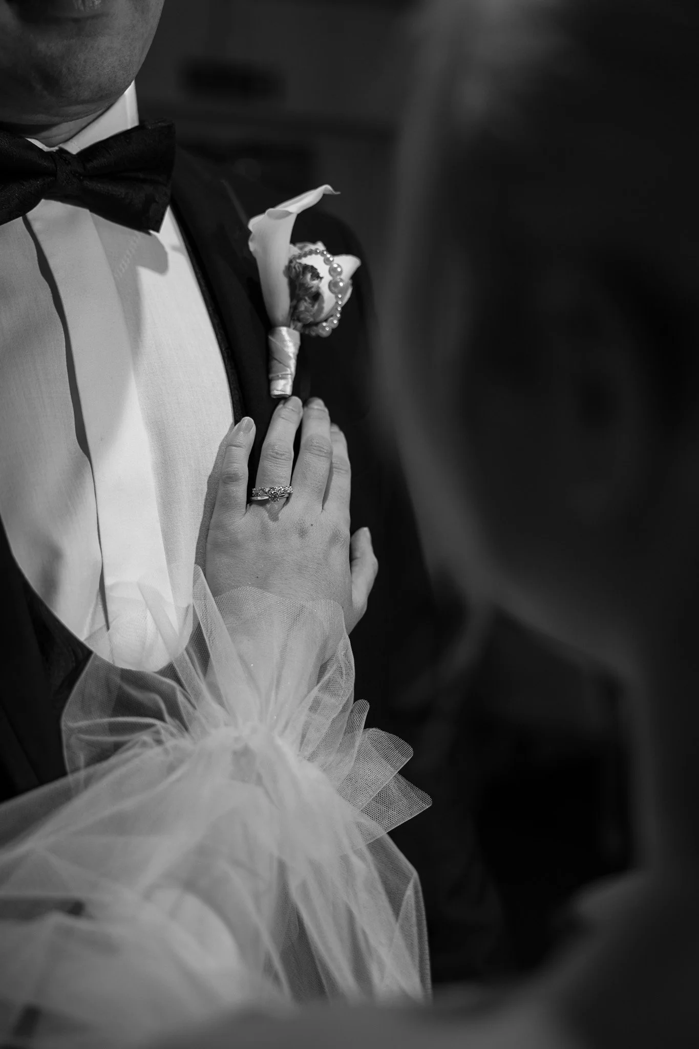 Black and white wedding detail capturing bridal styling and soft tulle textures.
