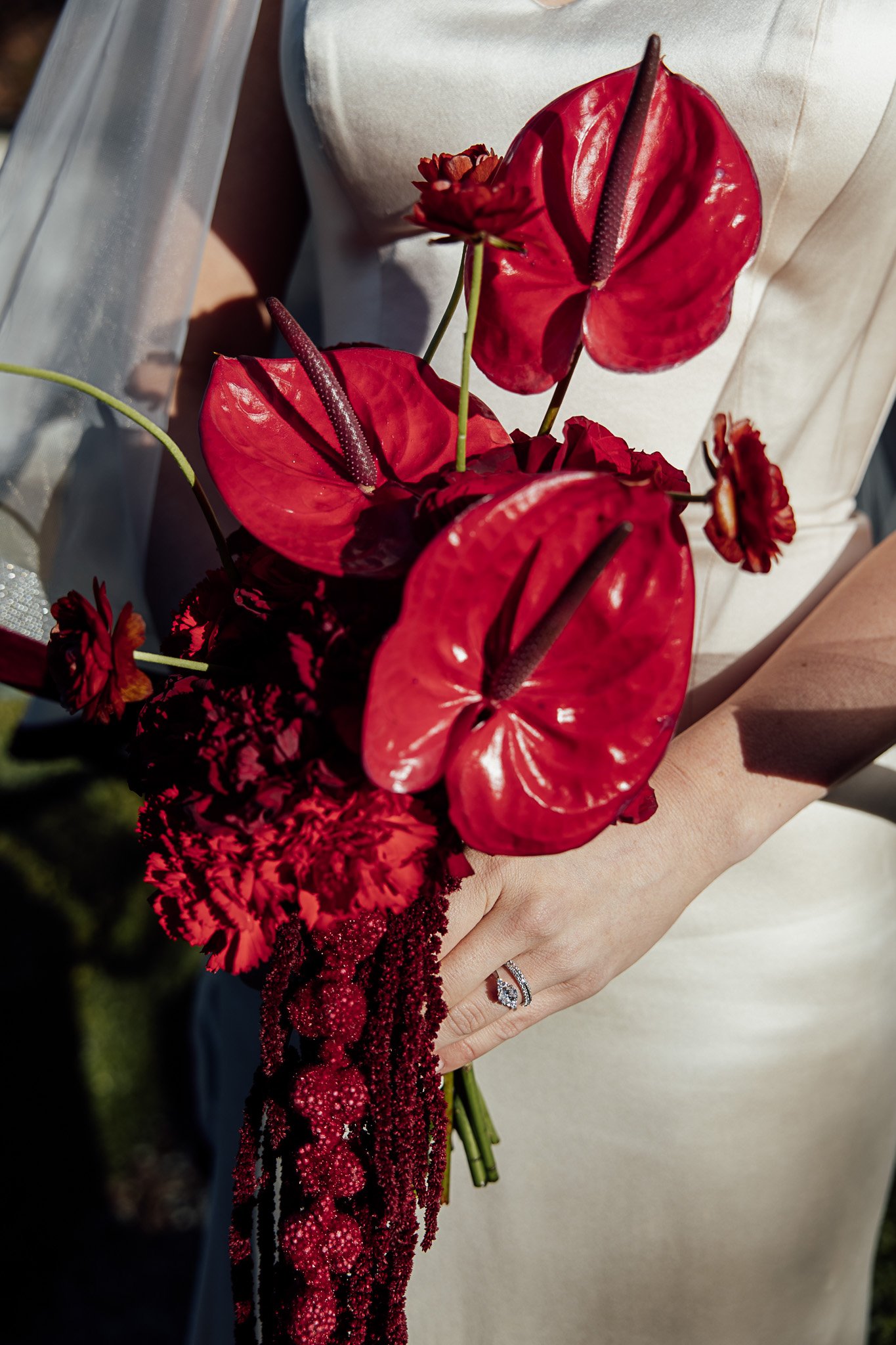 Red anthurium bridal bouquet with cascading textures at a Byre Barn Kent wedding styled shoot