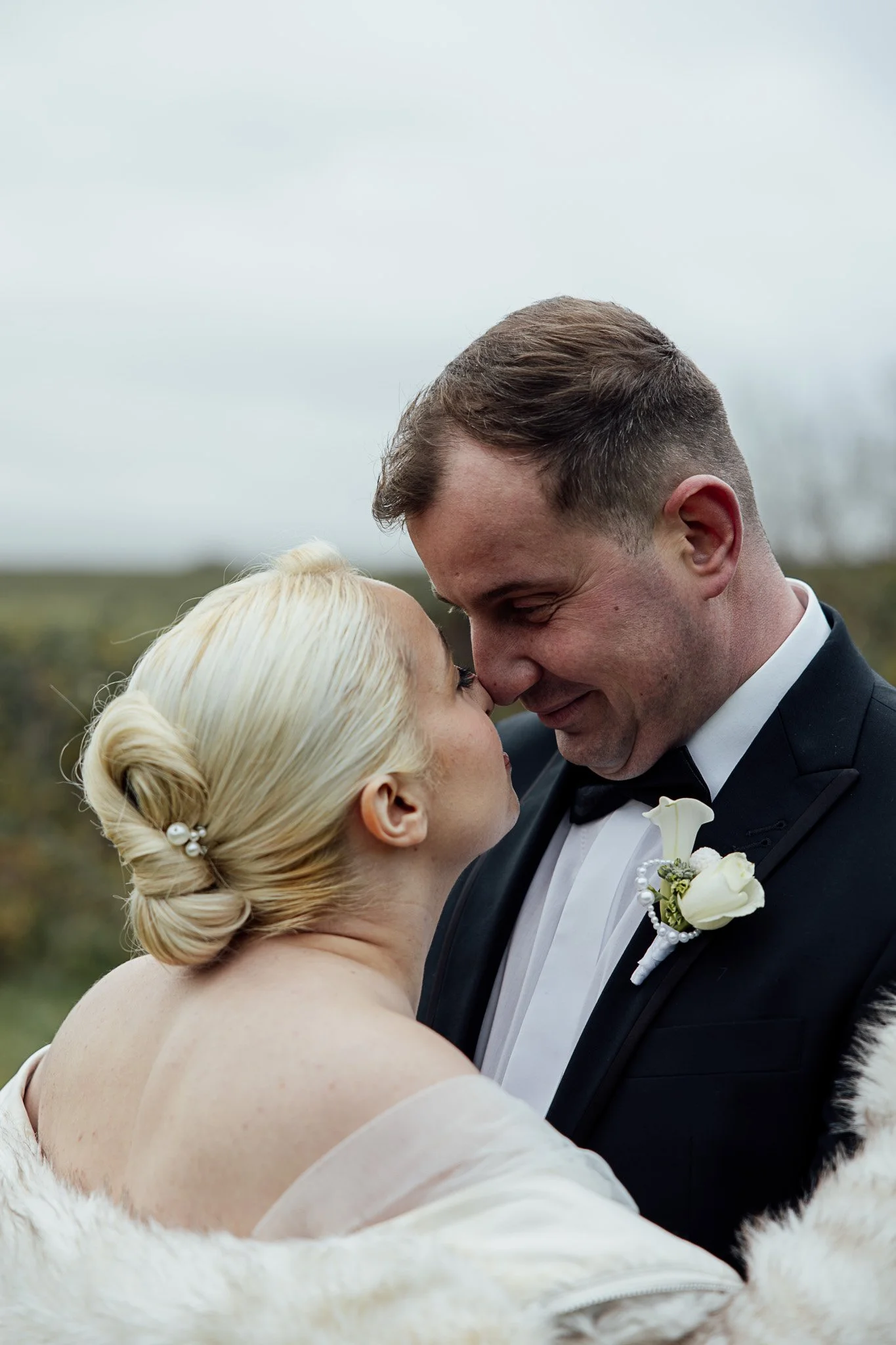 Natural outdoor wedding portrait of a bride and groom sharing a quiet moment during a styled shoot in Kent.