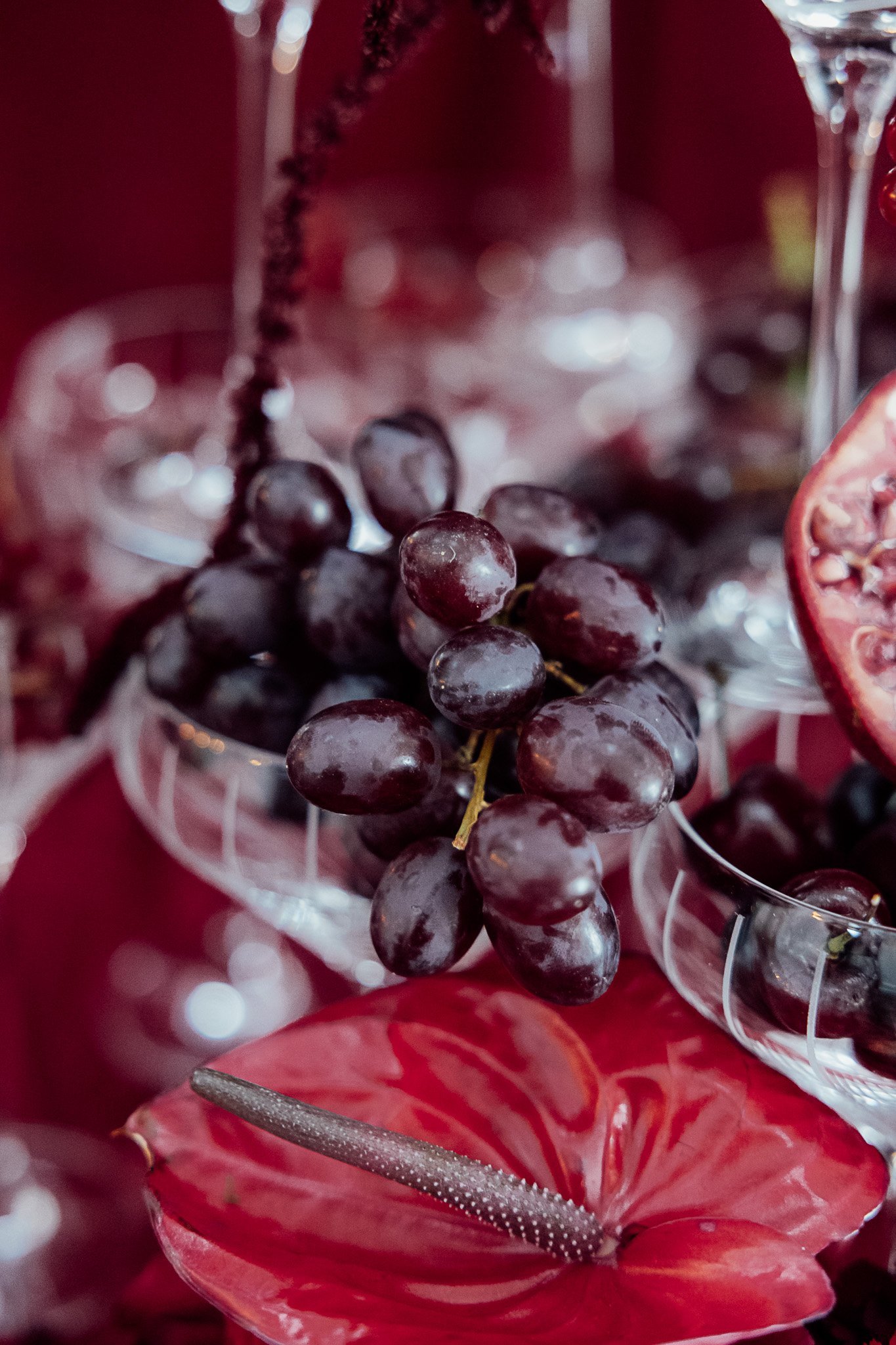 Styled wedding table detail with grapes and rich red tones at Byre Barn Kent