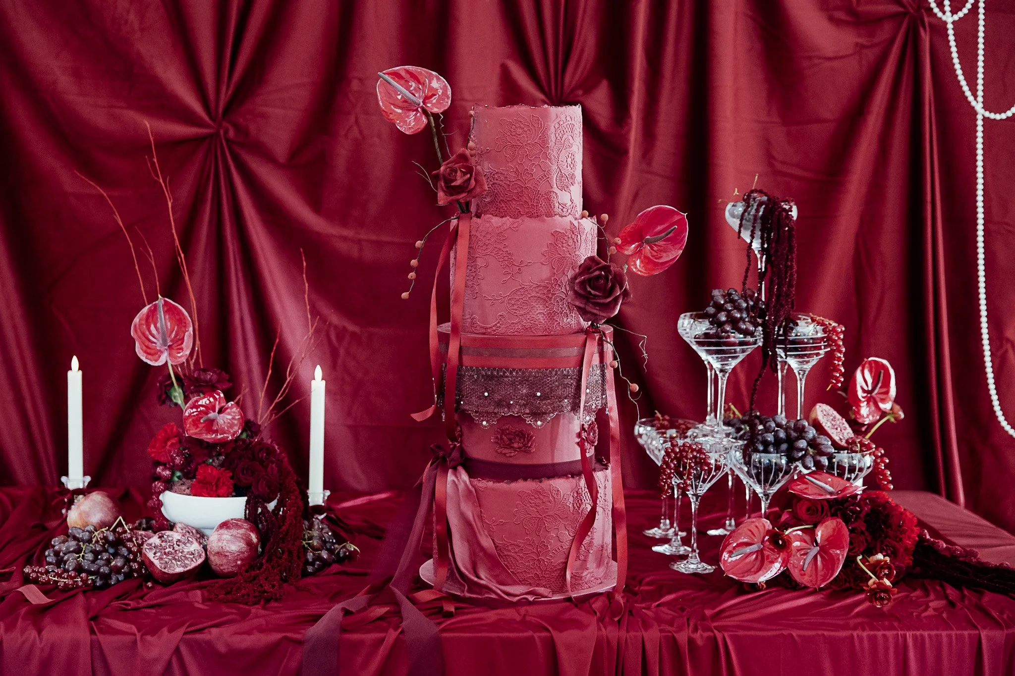 Luxury wedding cake and tablescape styling in rich red tones at Byre Barn Kent