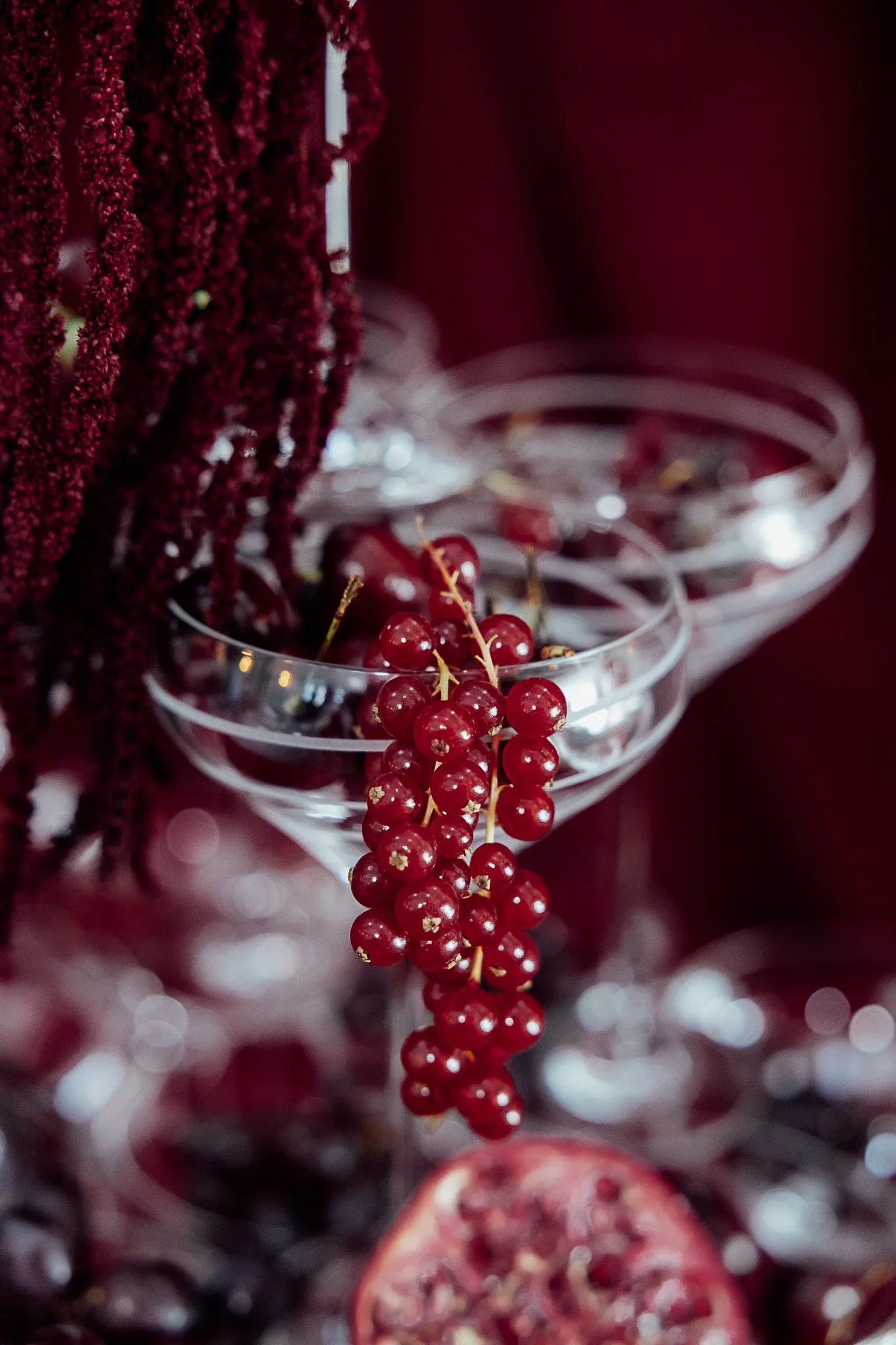 Styled champagne coupe detail with red berry accents at Byre Barn Kent wedding