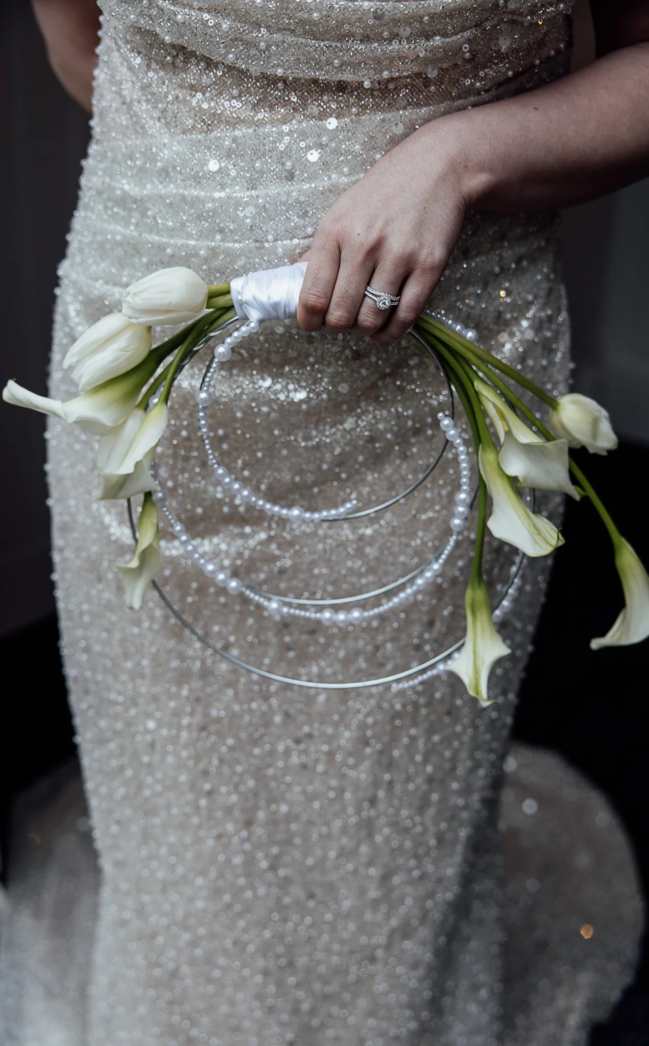 Elegant white wedding bouquet featuring seasonal florals and pearl details, styled for a Kent venue shoot.