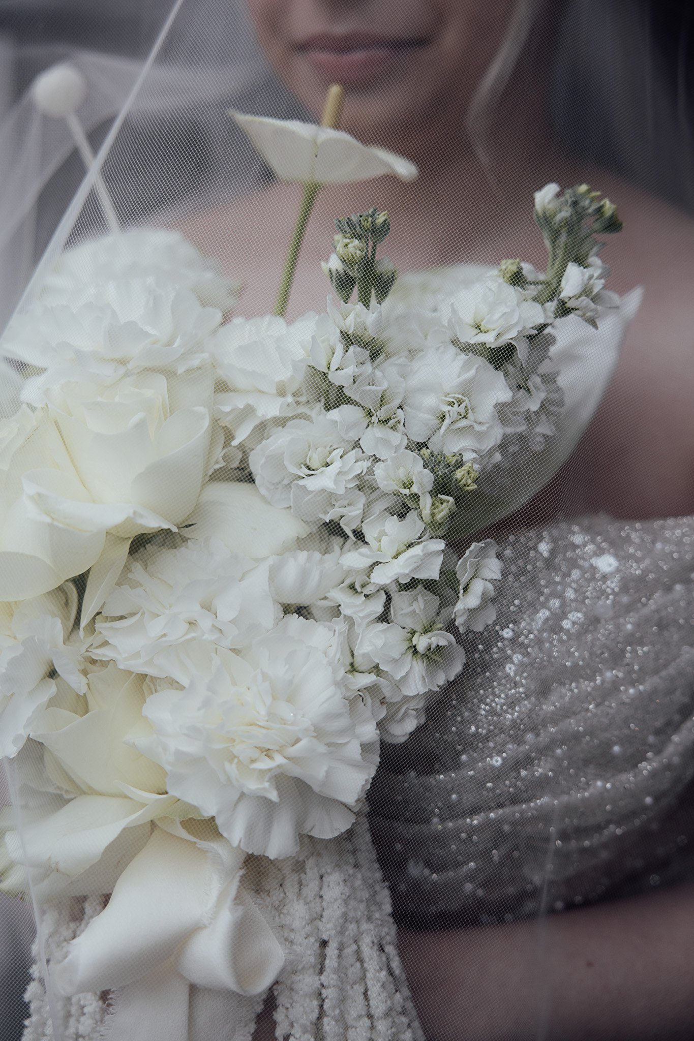 Soft white wedding bouquet featuring seasonal florals and delicate textures, styled for a Kent wedding shoot.