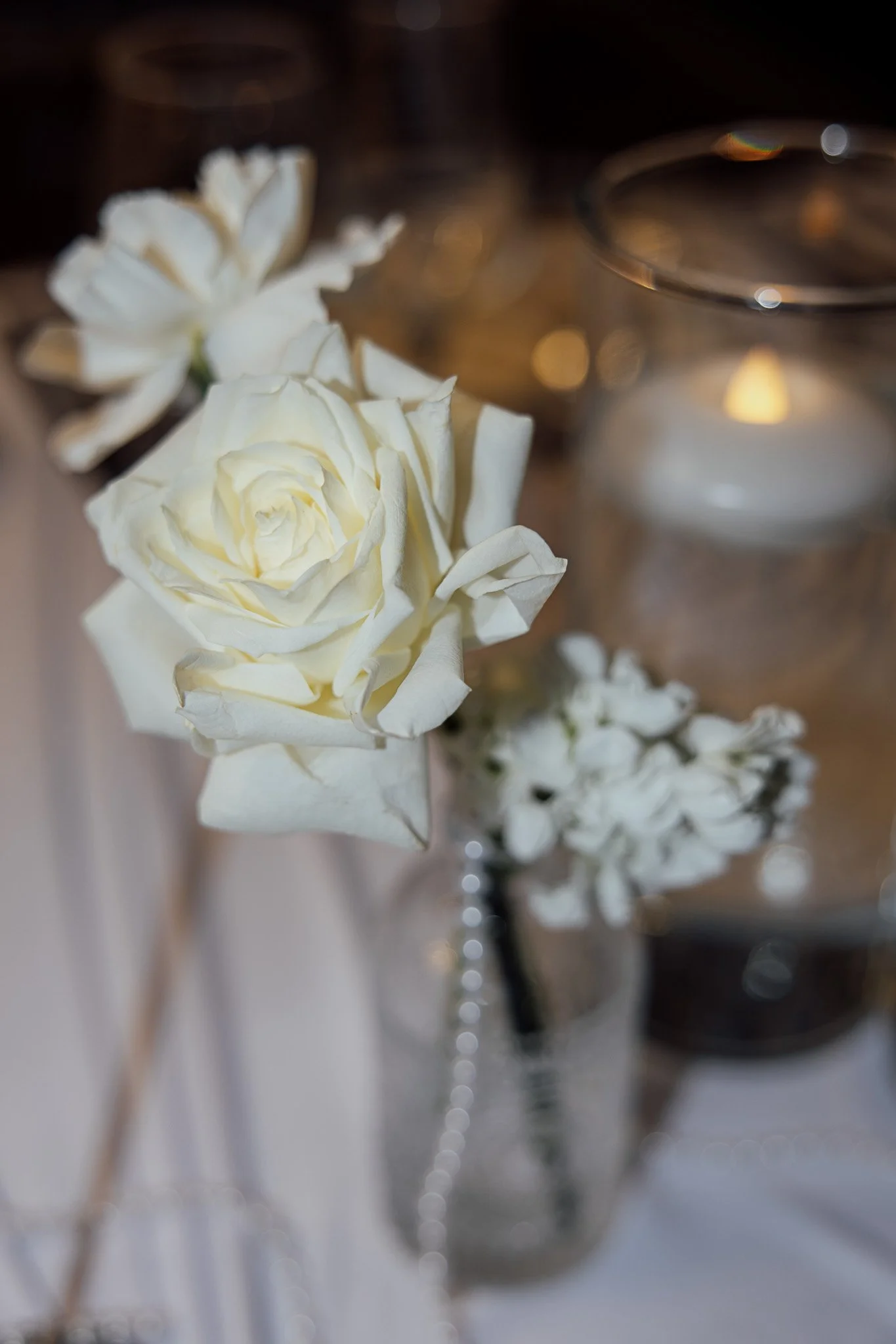 White rose wedding flower detail styled with candlelight for a romantic Kent venue shoot.