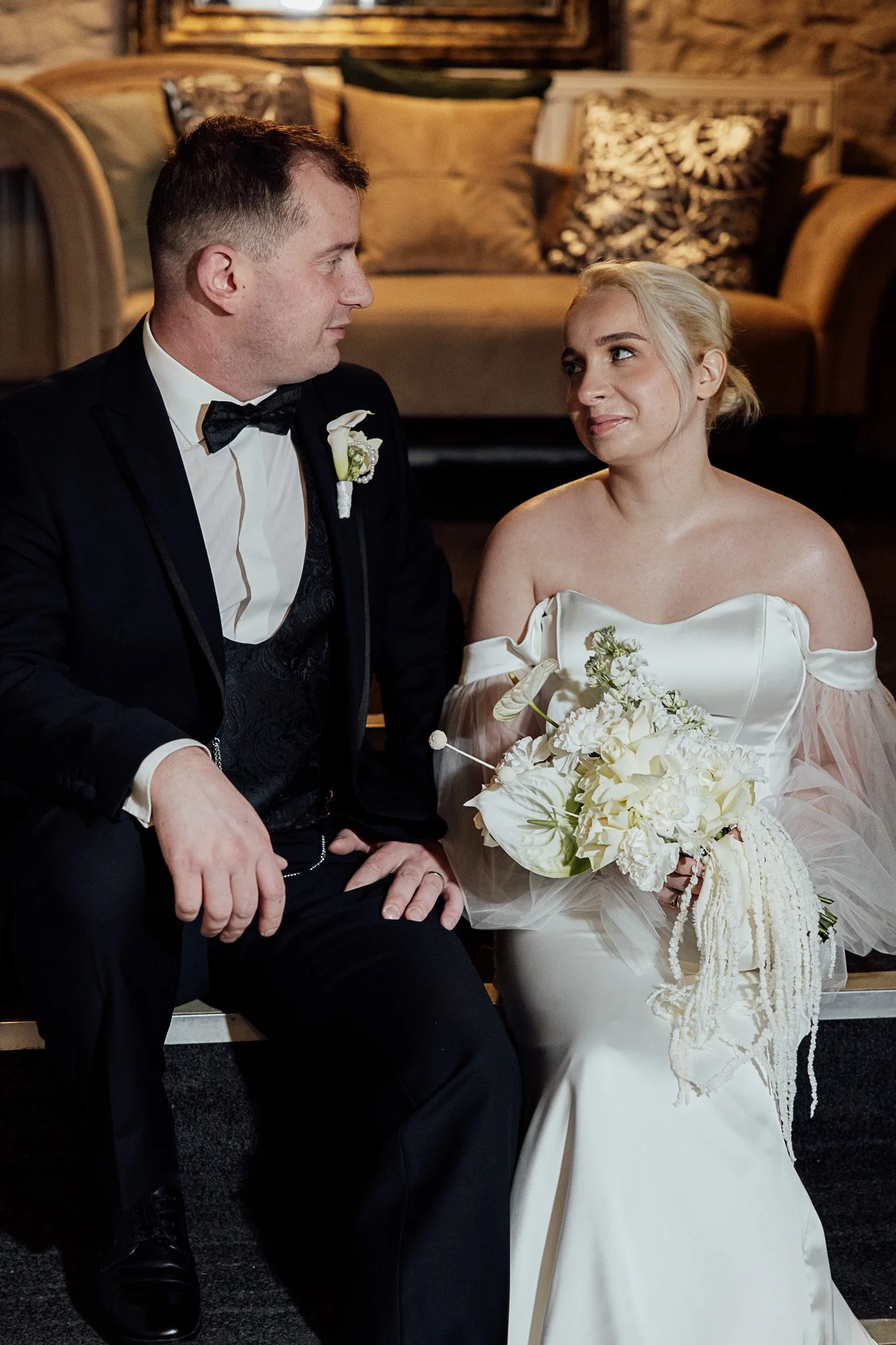 Bride and groom seated together during a romantic styled wedding shoot in Kent.