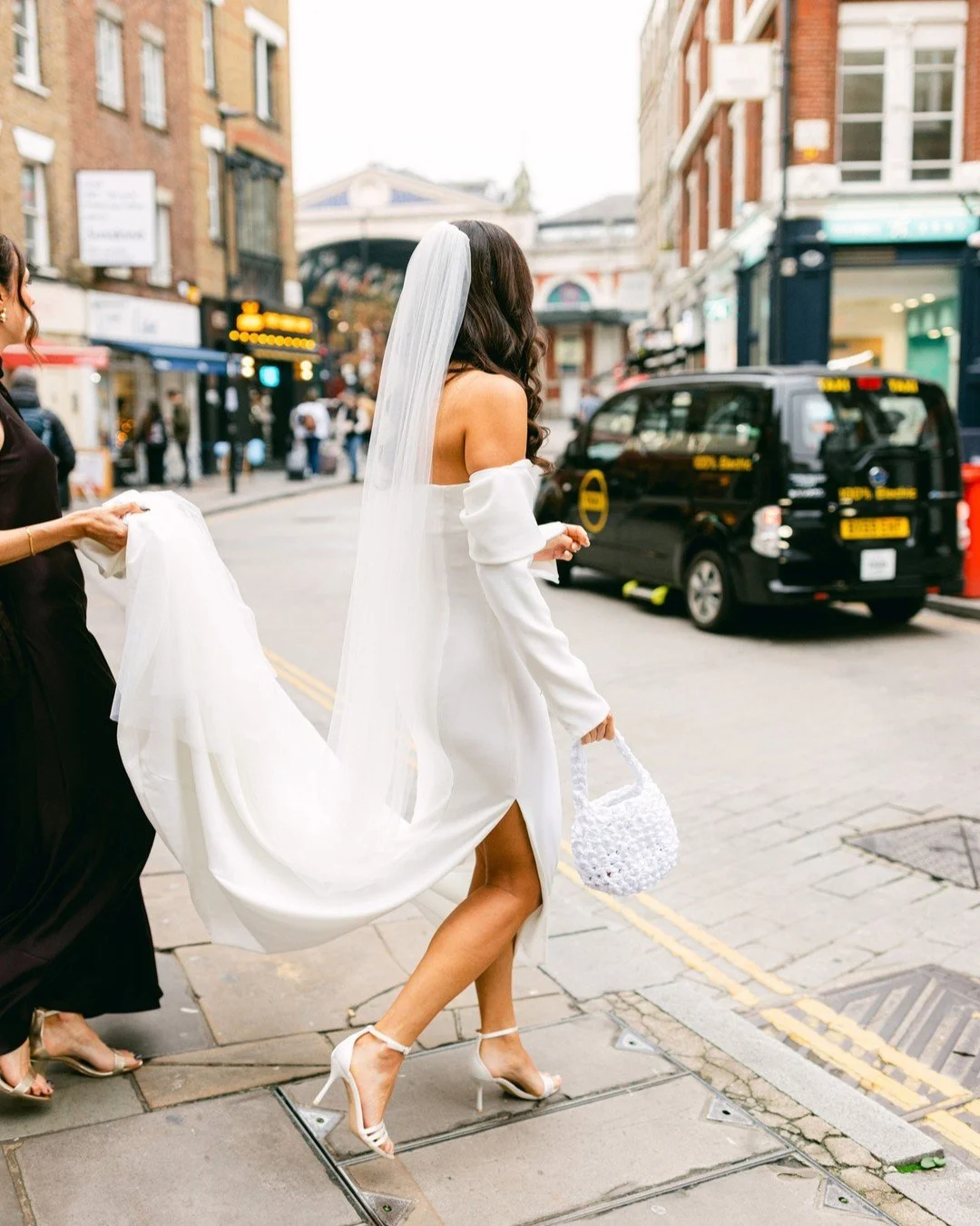When your wedding ceremony is just a quick cab ride away 🖤

Loved capturing this candid moment of beautiful bride Isy looking so chic in her @bonbride dress in central London. It's often the little inbetween moments like this one that become some of